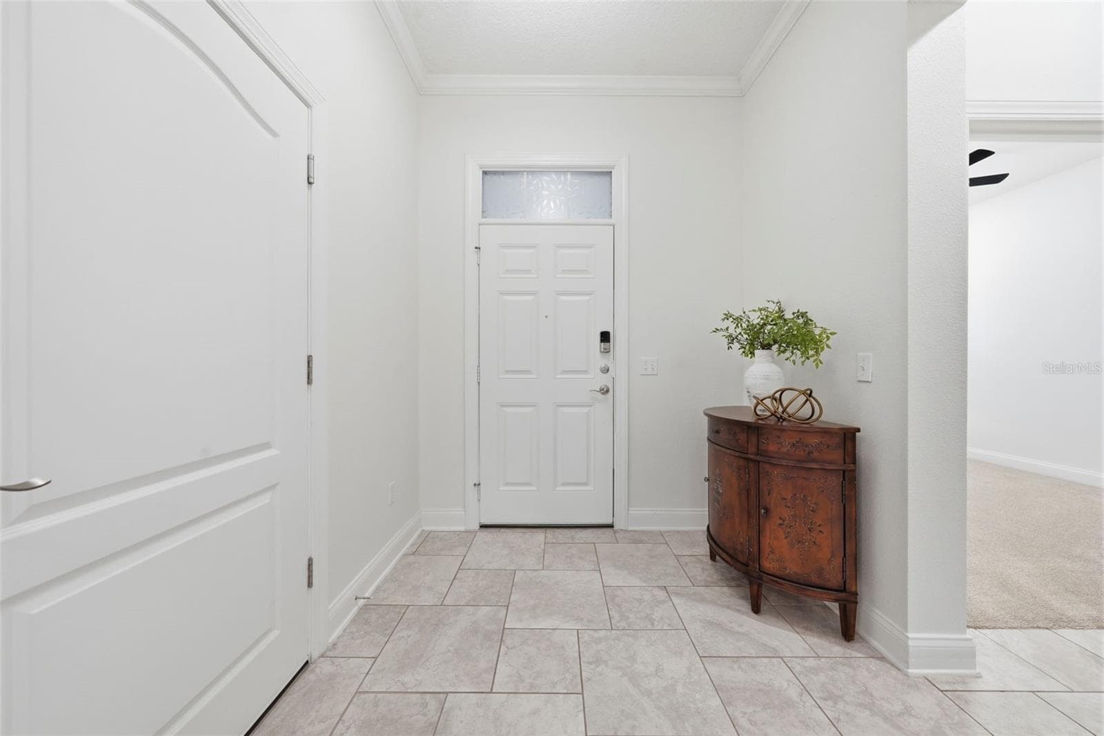 Foyer with garage entry to the left - 16716 ABBEY HILL CT, CLERMONT