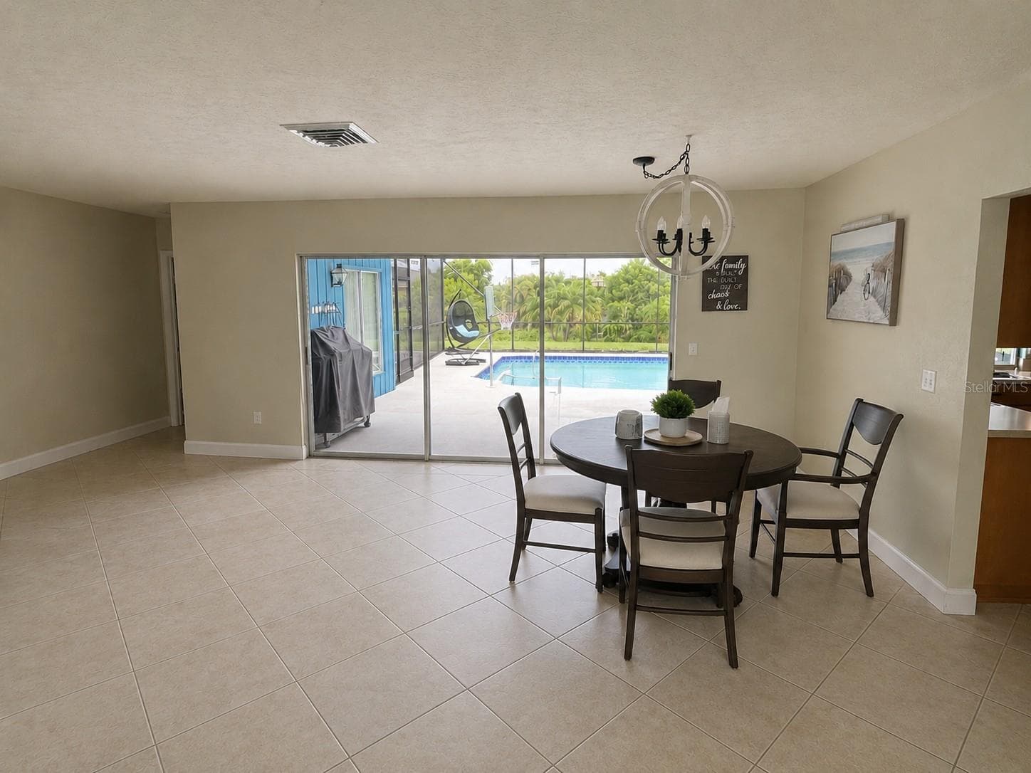 Living/dining area overlooking pool - 1009 INDIAN HILLS CT, VENICE