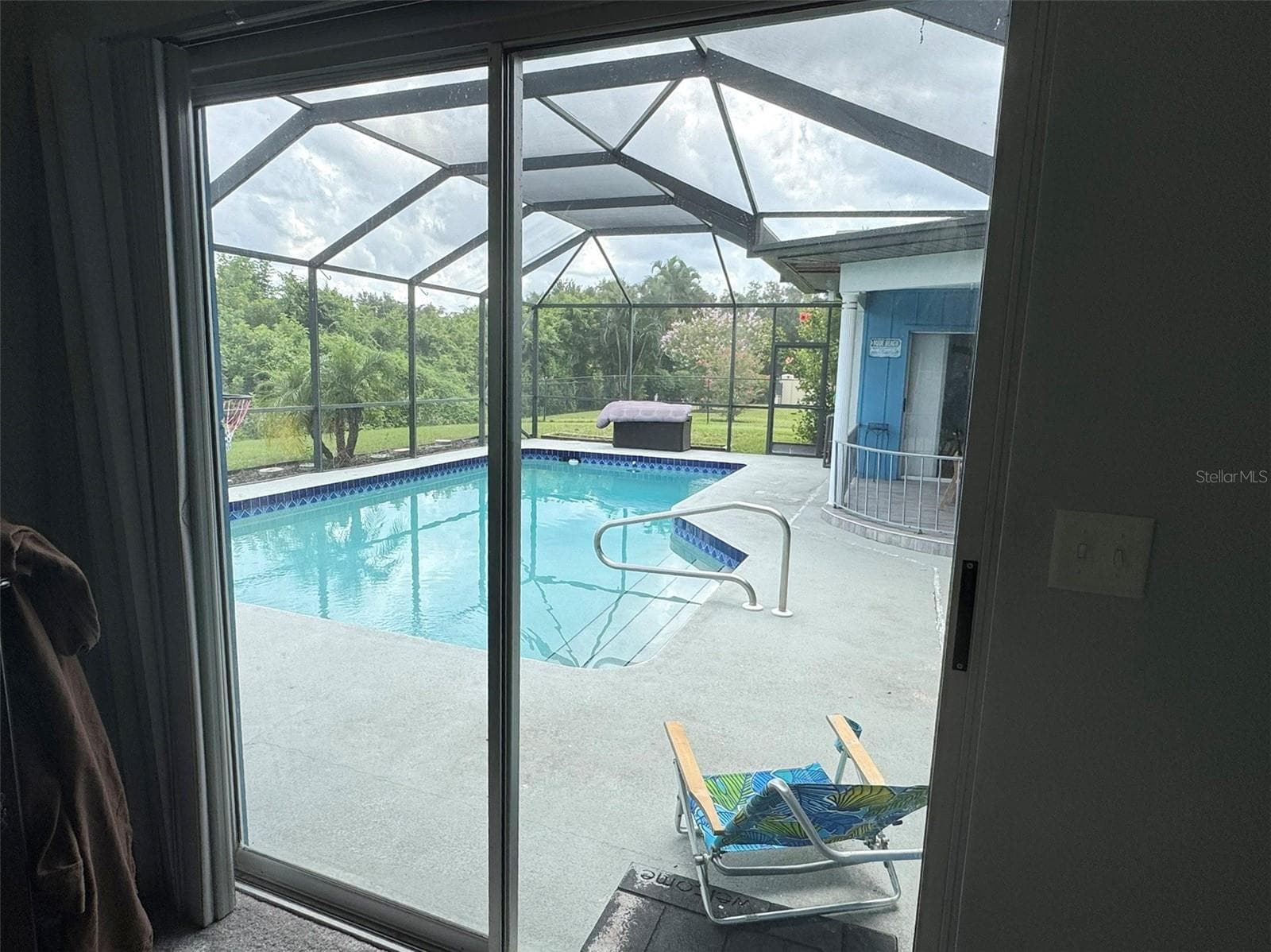 Primary bedroom slider onto pool deck - 1009 INDIAN HILLS CT, VENICE