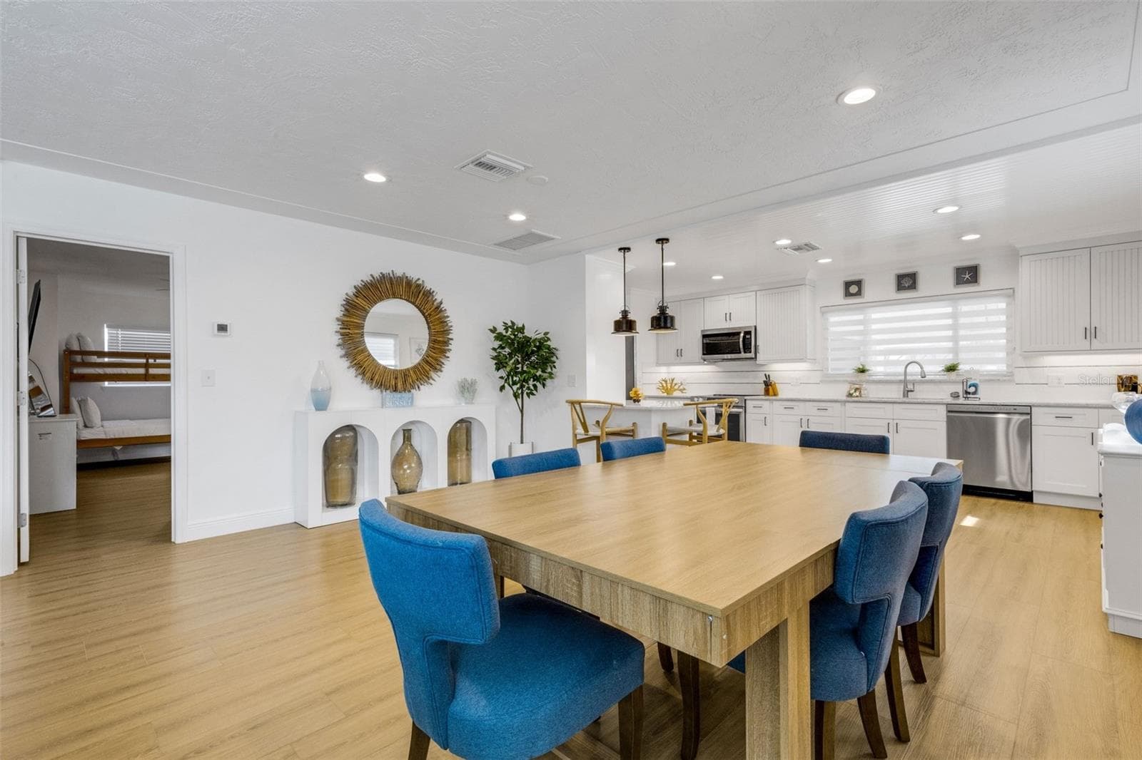 Open dining area with a clear view toward the beautifully updated kitchen. - 18317 SUNSET BLVD, REDINGTON SHORES