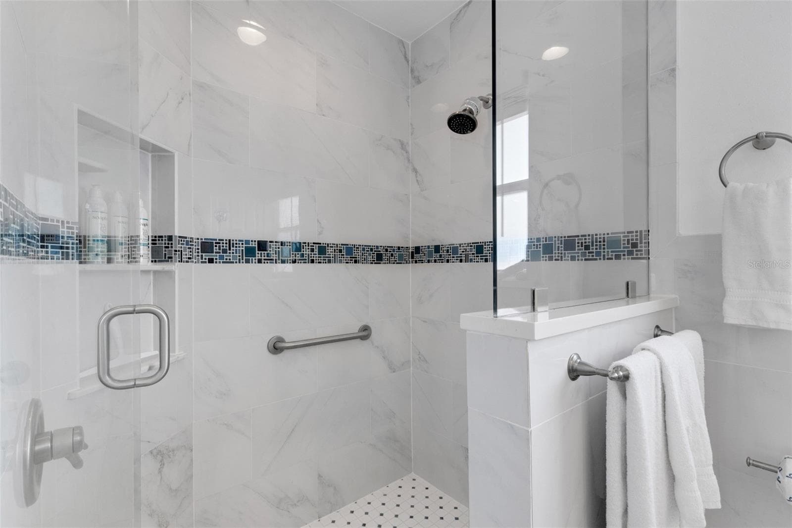Beautiful walk-in shower with glass enclosure, tiled walls and built-in niche. - 18317 SUNSET BLVD, REDINGTON SHORES