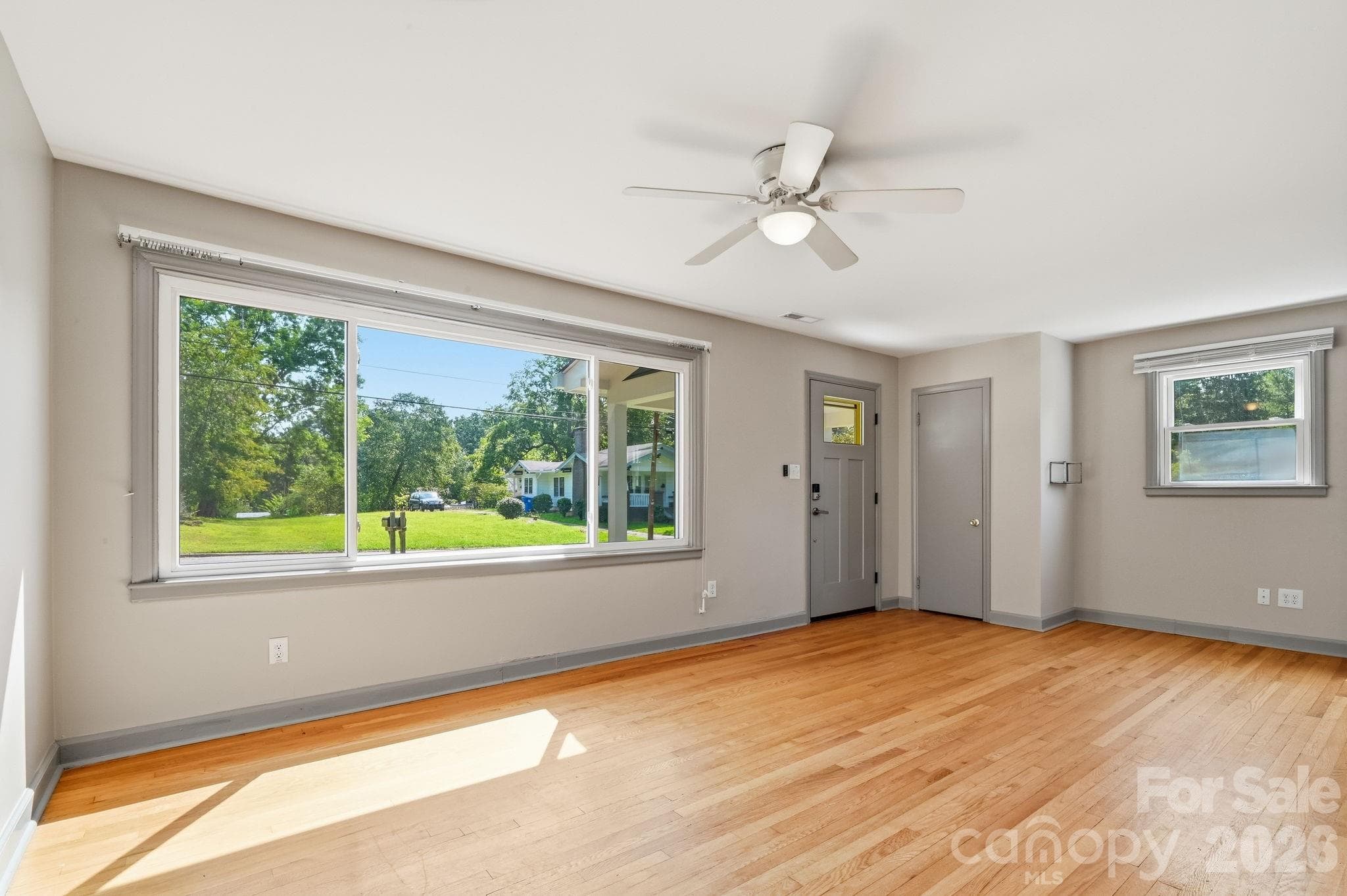 Upper Unit 2 living room with large window and lots of natural light - 77 Trotter Place, Asheville