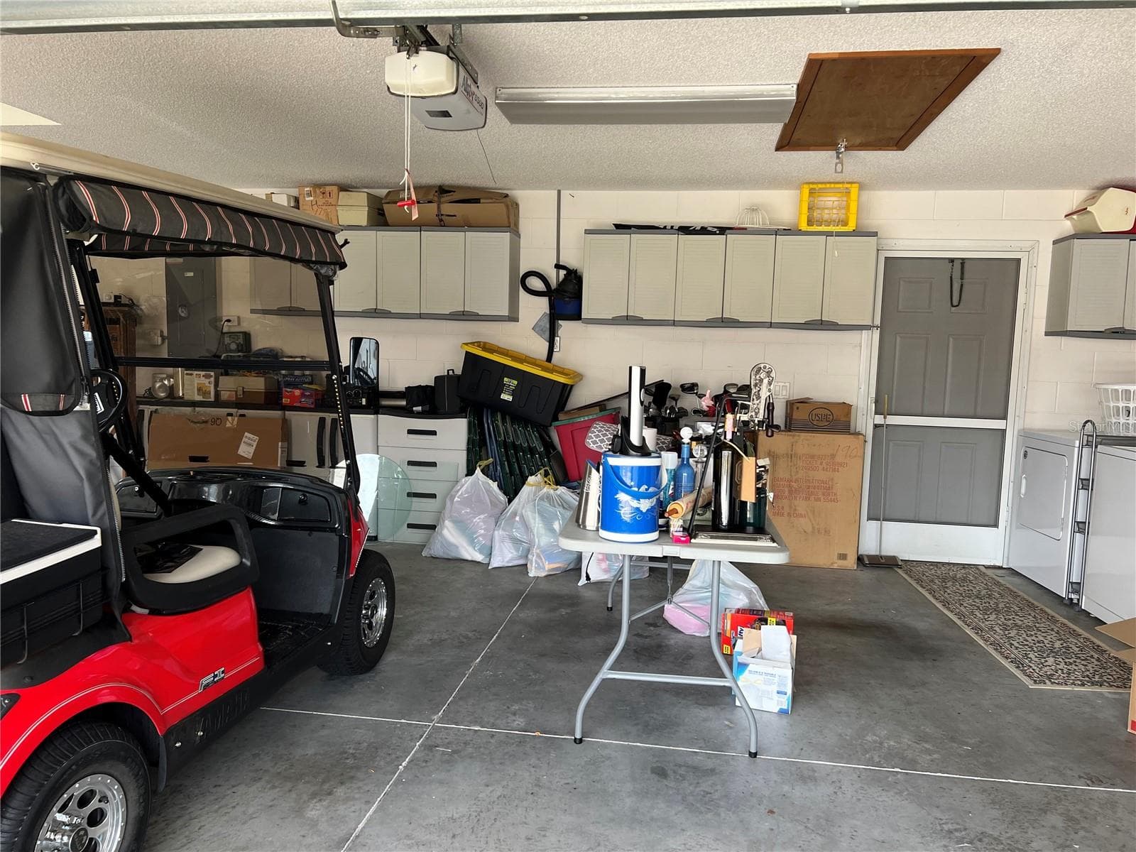 Two car garage with door to side of the courtyard - 1842 PUERTO BELLO DR, THE VILLAGES