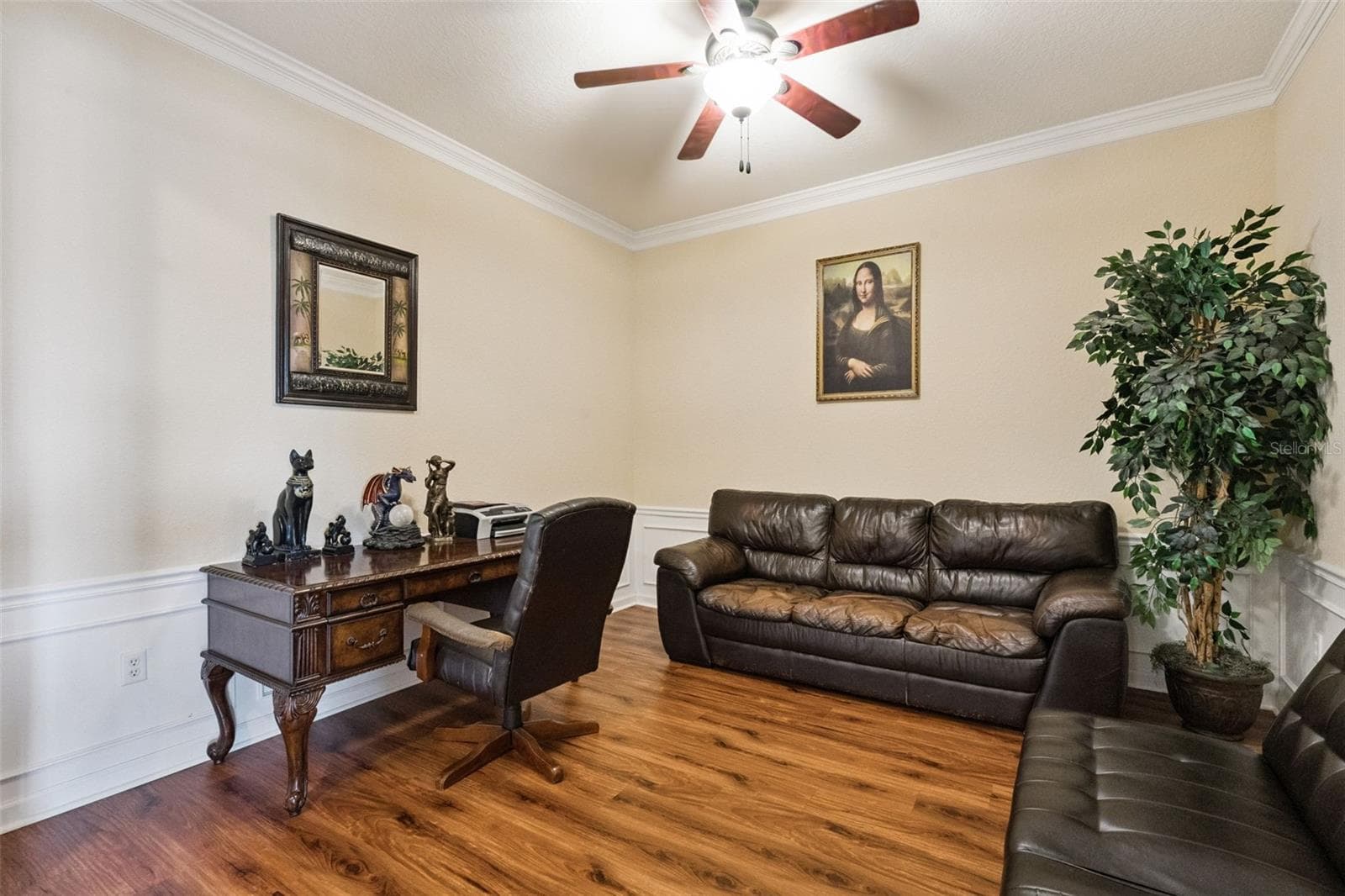 Flex Room Perspective:Alternate view of the versatile front room highlighting warm wood-look floors, neutral tones, and flexible layout possibilities. - 4840 CAYVIEW AVE #405, ORLANDO