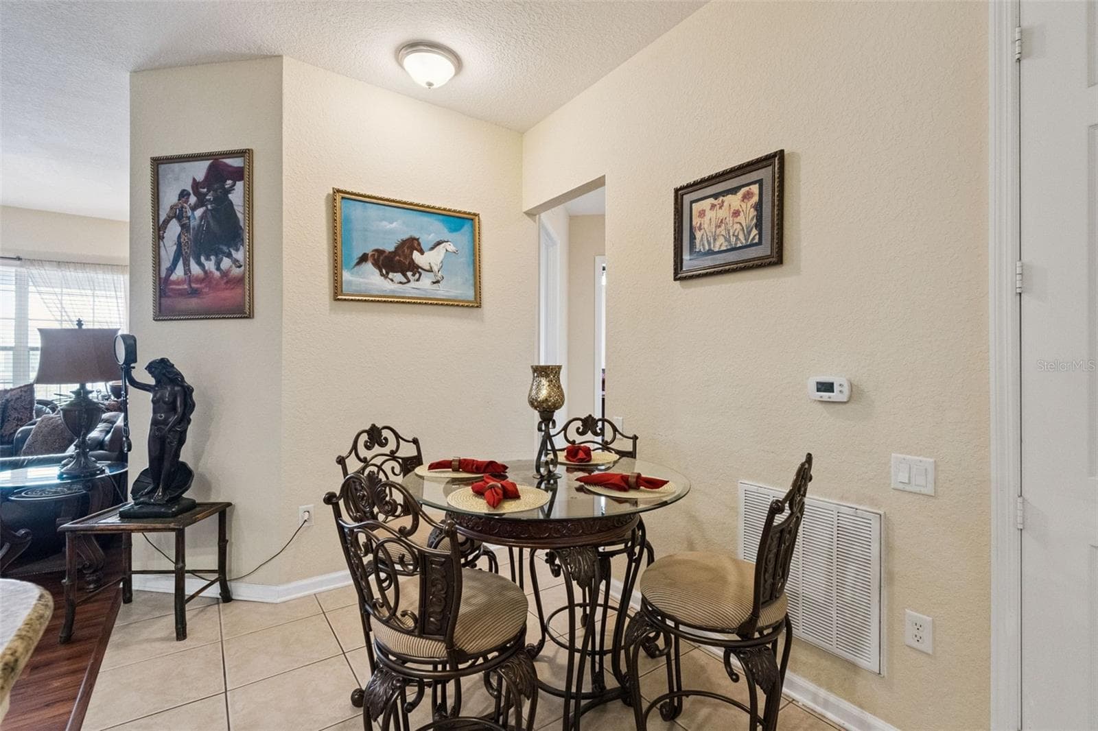 Dining Area Perspective:Cozy dining nook offering neutral paint, low-maintenance tiled floor, and clear sightlines through to the main living areas. - 4840 CAYVIEW AVE #405, ORLANDO