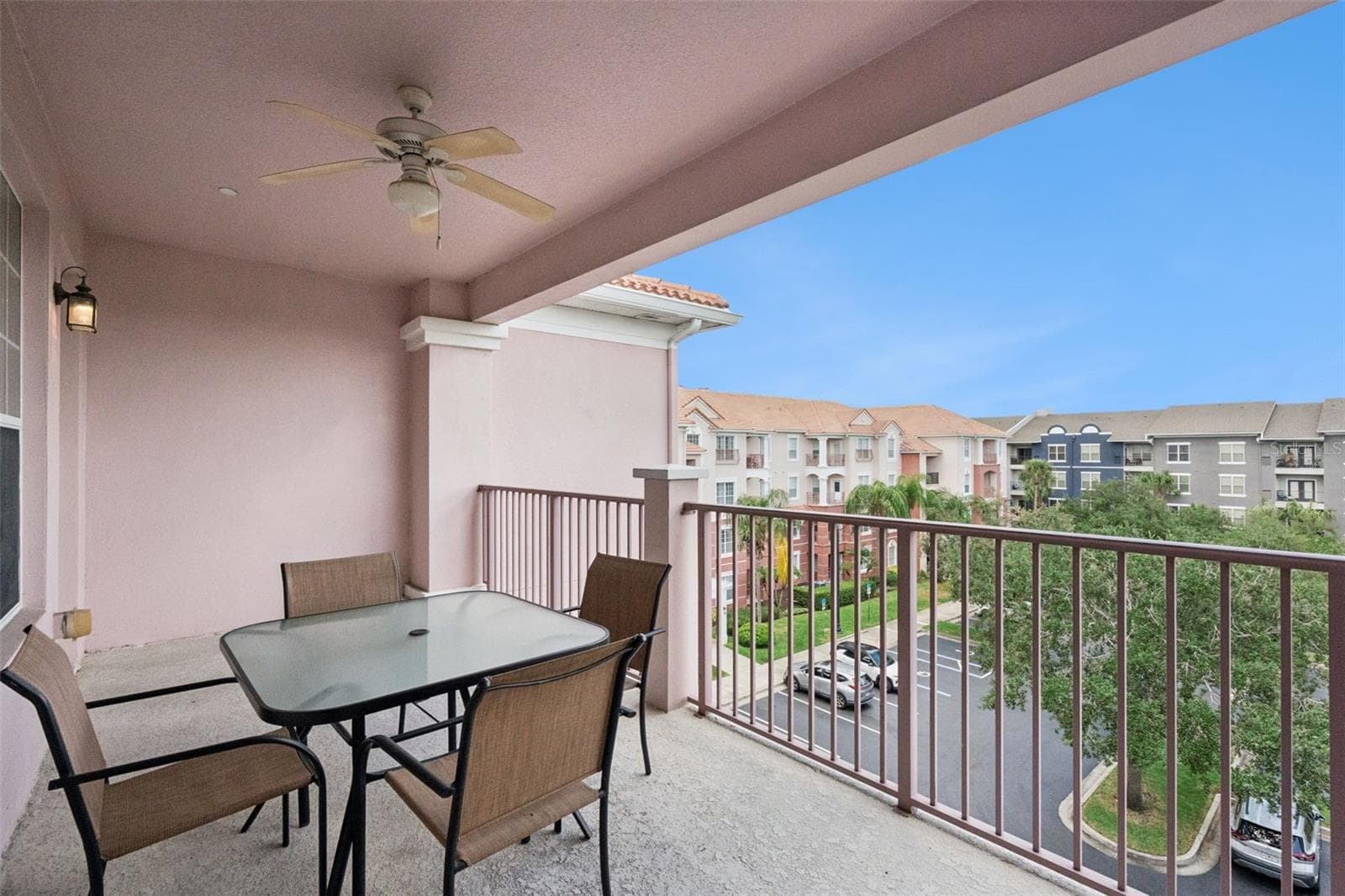 Covered Balcony Overview:Generously sized covered balcony with an outdoor ceiling fan, patio dining setup, and elevated views over the community grounds. - 4840 CAYVIEW AVE #405, ORLANDO