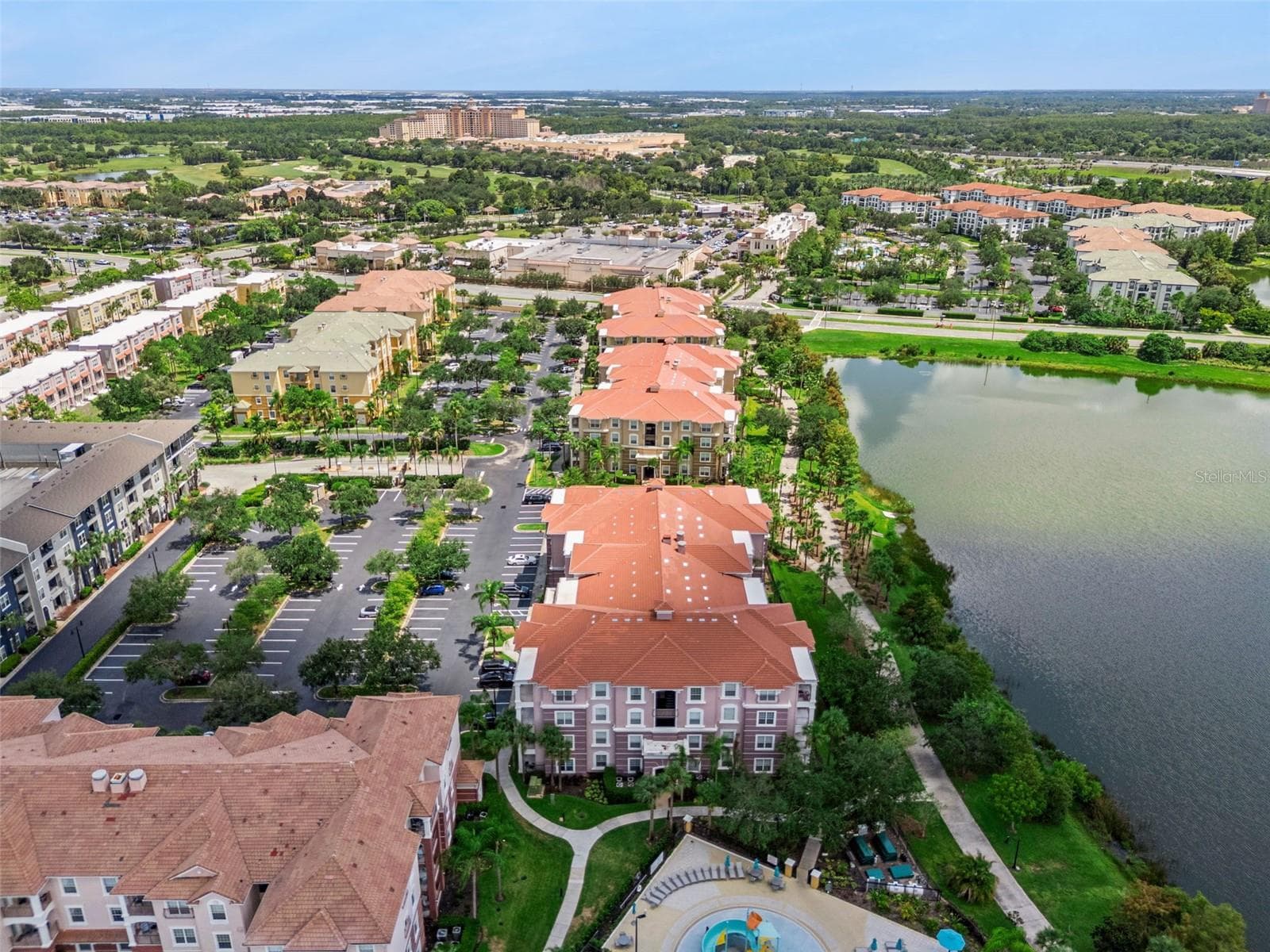 Waterfront Lineage Aerial:Aerial perspective showing the row of lakefront residences, lush green space, walking path, and proximity to regional attractions. - 4840 CAYVIEW AVE #405, ORLANDO