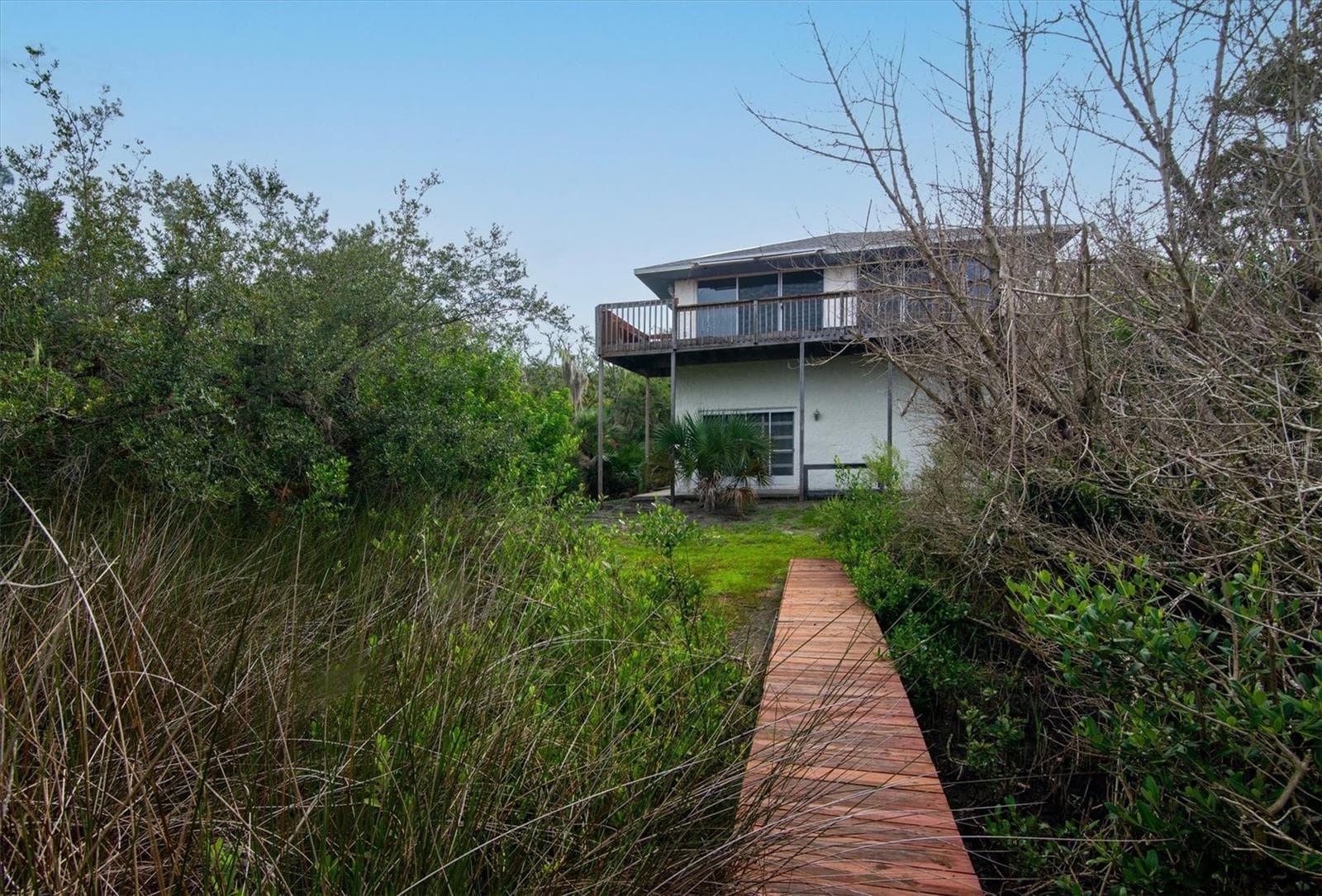 View from dock walkway back to house. Mangroves present on either side - 1835 OAK PL, FLAGLER BEACH