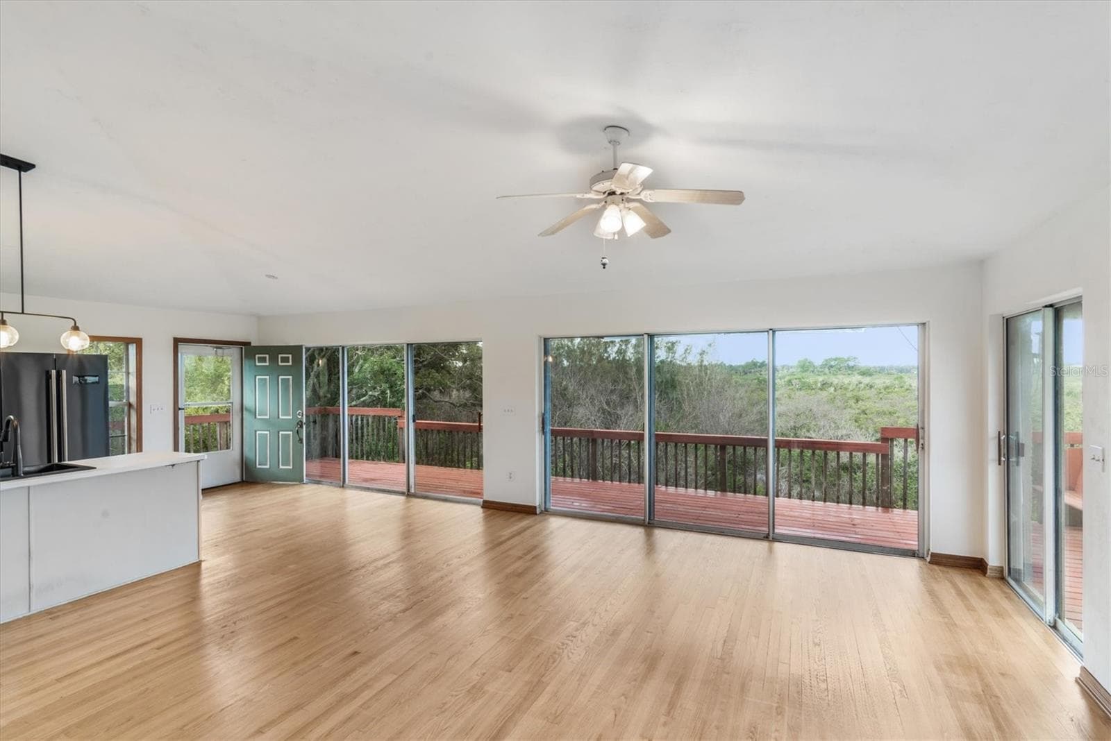 View from the living room to the deck which faces the river and intercoastal waterway - 1835 OAK PL, FLAGLER BEACH