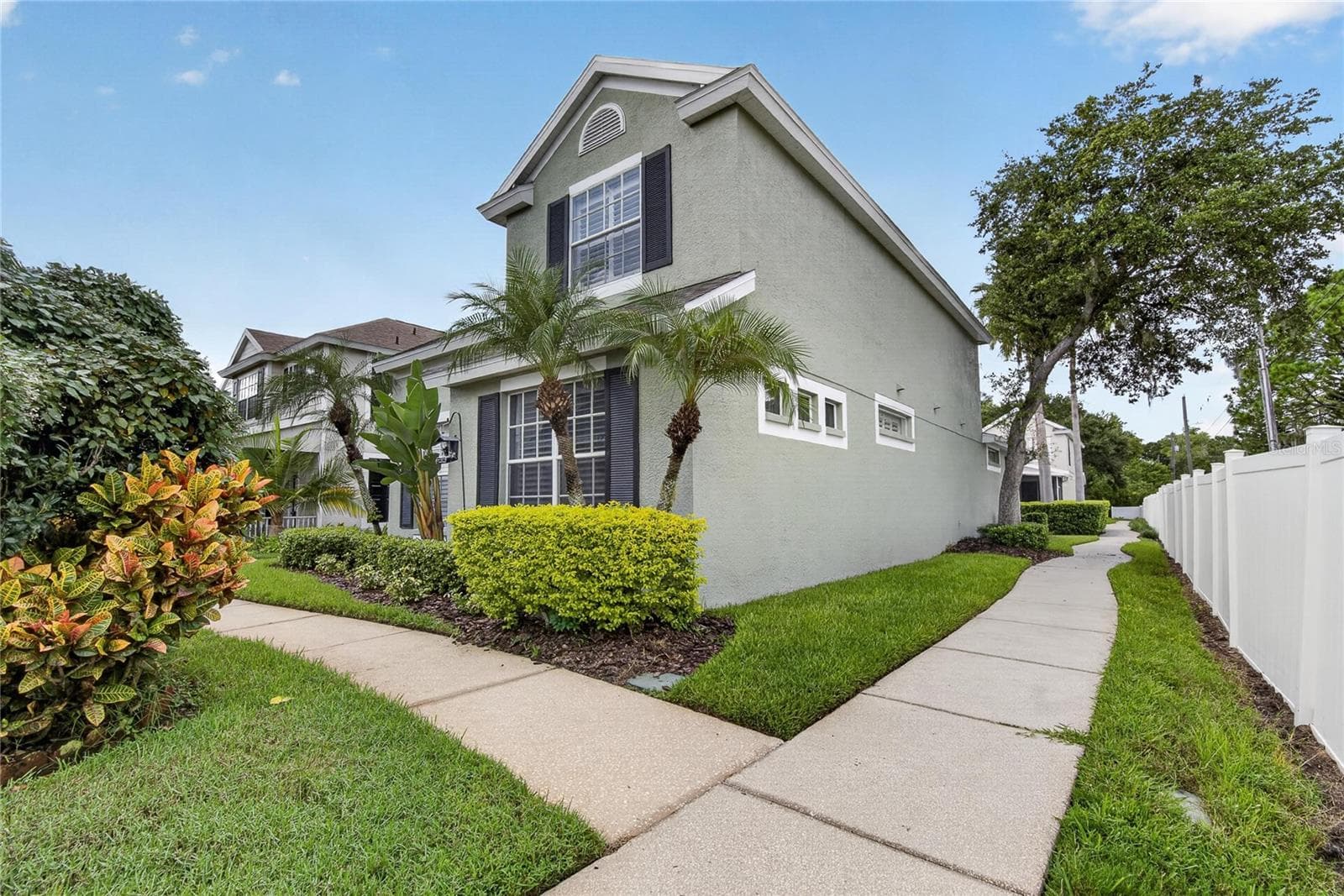 Sidewalk leading to the rear of the home and private garage. - 10807 SIERRA VISTA PL, TAMPA
