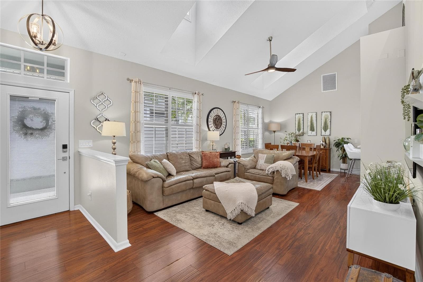 Light-filled living and dining area with soaring ceilings and dormer windows. - 10807 SIERRA VISTA PL, TAMPA