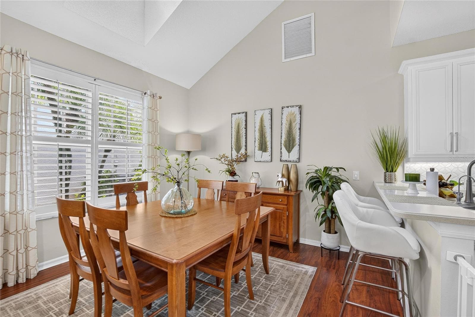 Bright dining area with soaring ceilings and plantation shutters. - 10807 SIERRA VISTA PL, TAMPA