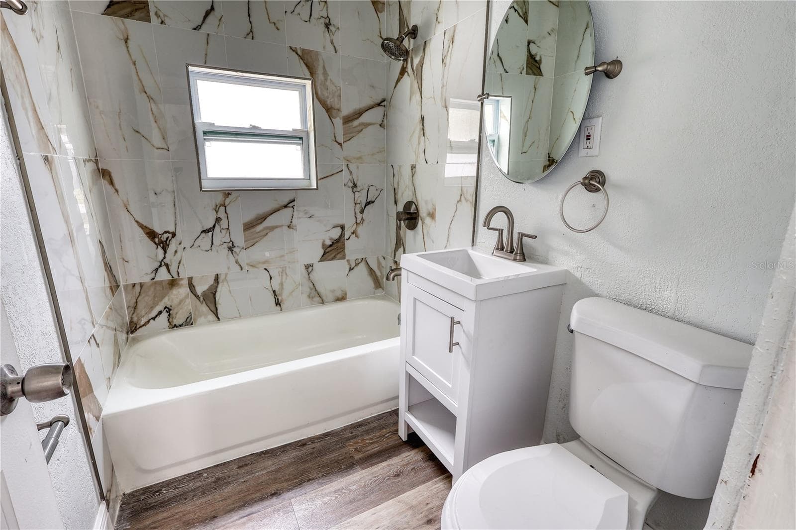 Updated bathroom featuring fully tiled walls surrounding the tub and shower. - 116 44TH ST S, ST PETERSBURG