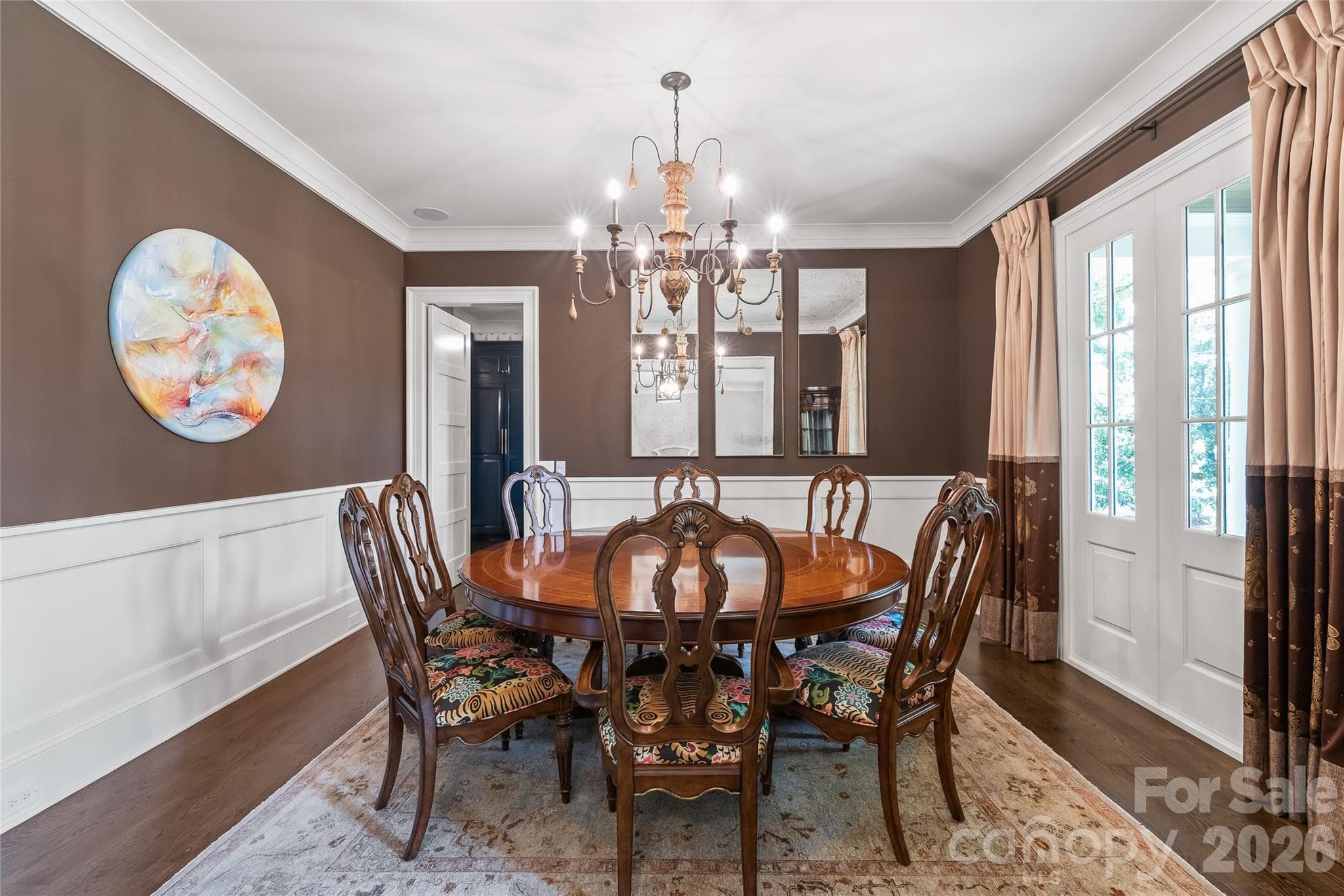 Wainscoting, crown molding and double faux door windows add ambiance and style for those special meals - 2800 Wintergreen Drive, Charlotte