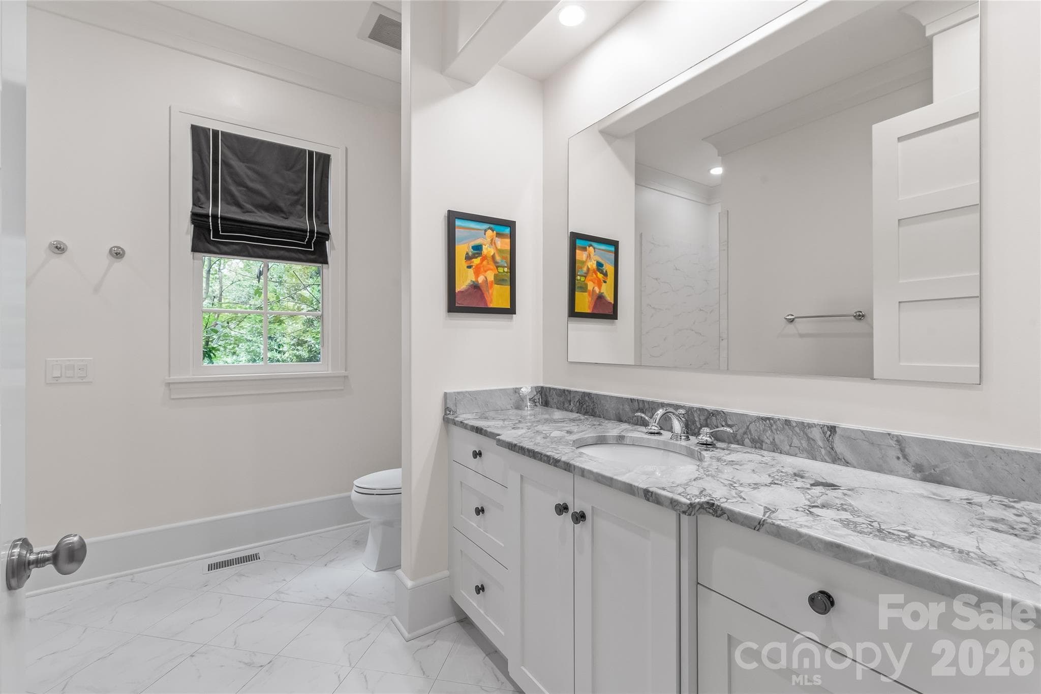 Enter the Main floor guest bath, with a wide doorway and ample counter space. - 2800 Wintergreen Drive, Charlotte