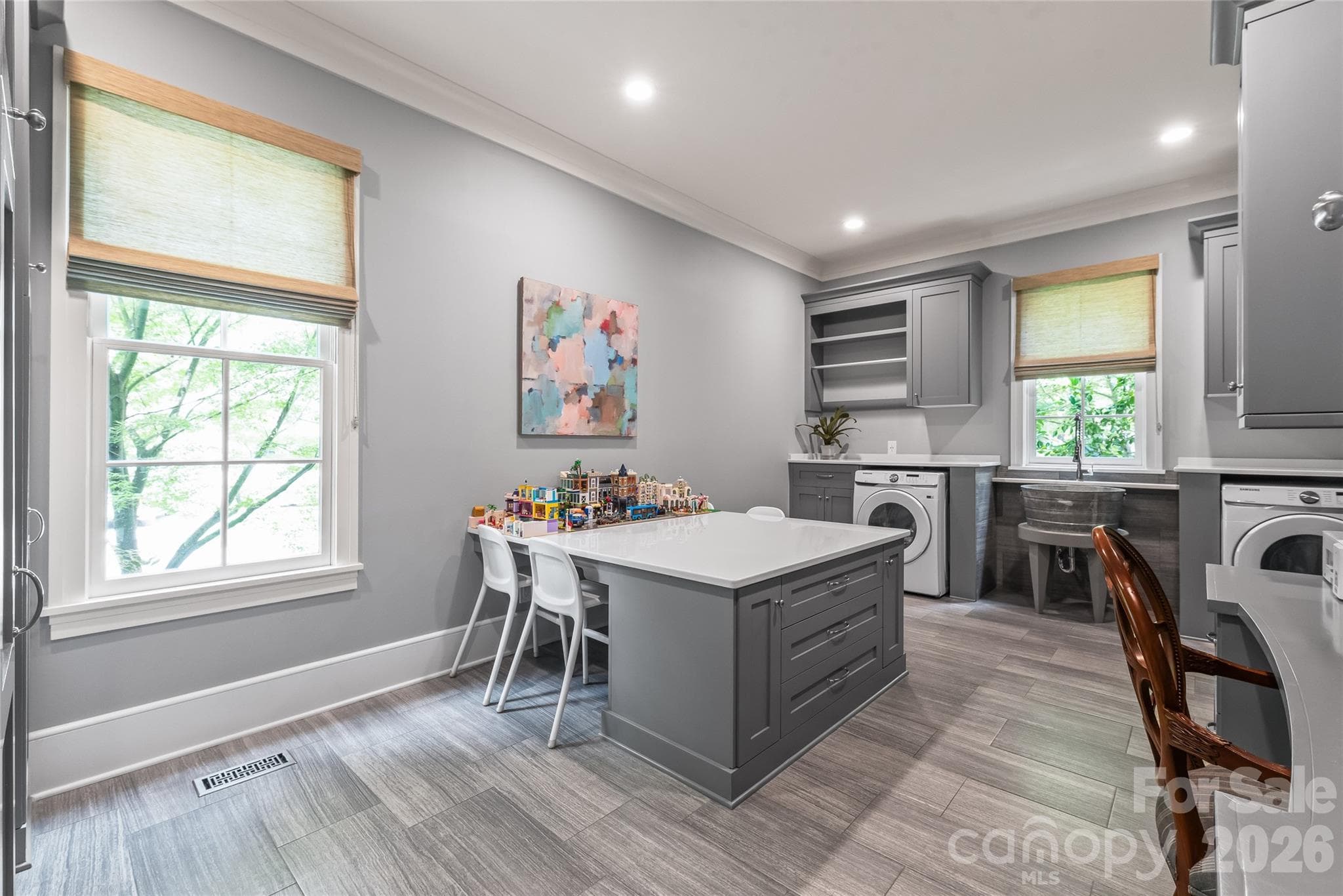 A room for everything. The resource room has storage, workstation, laundry and large center island - 2800 Wintergreen Drive, Charlotte