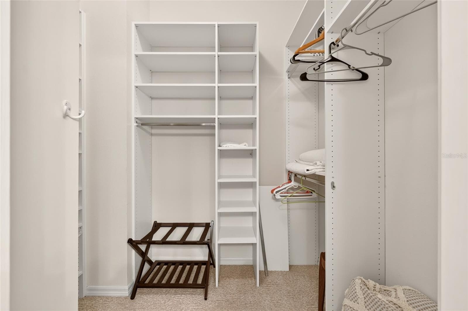Walk in primary bedroom closet with California Closets organization. Closet extends around the corner (hidden from view)! - 17198 SE 84TH KNIGHT AVE, THE VILLAGES