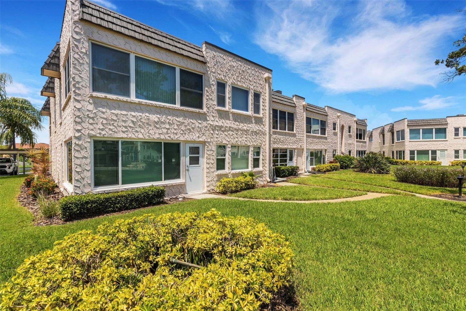 Rear of Unit with Pedestrian Door and Walkway to pool and Clubhouse - 112 ELMWOOD CIR #112, SEMINOLE