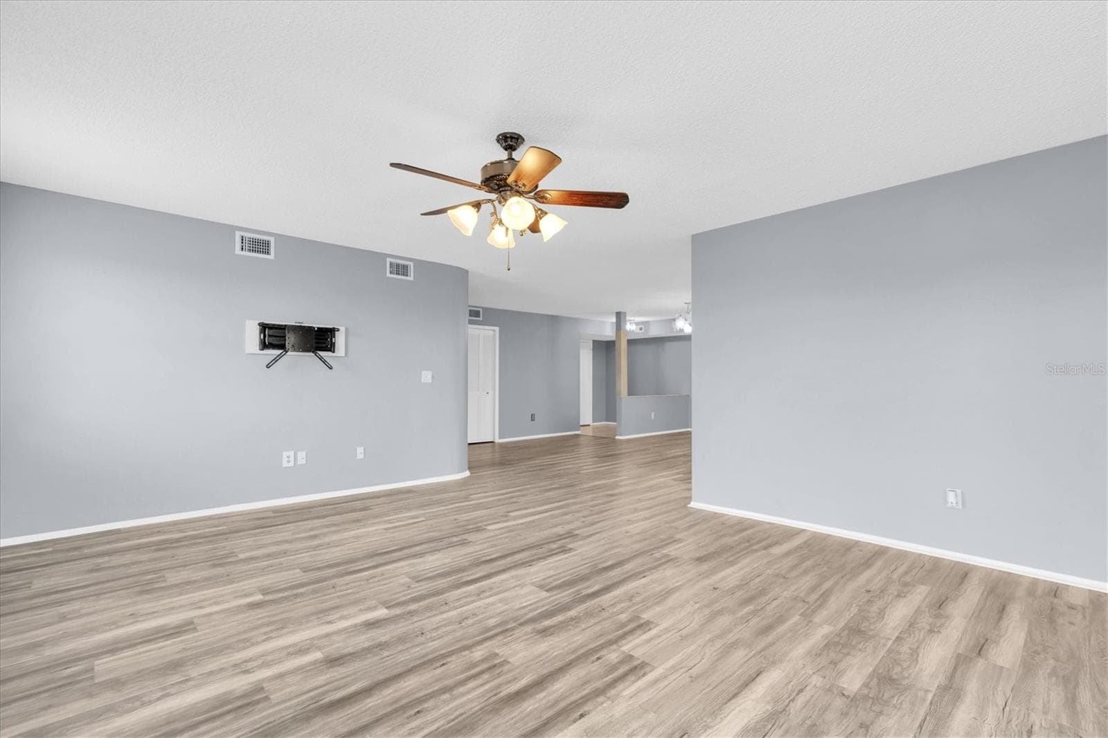 View of the living area from the French doors looking into the dining room and entryway. - 8198 TERRACE GARDEN DR #511, ST PETERSBURG