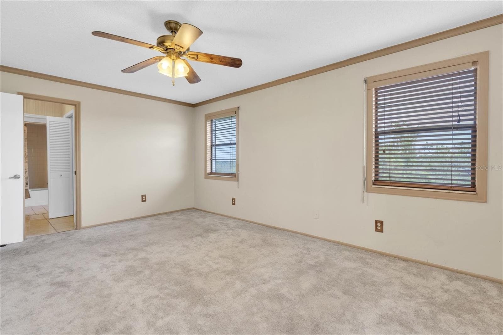 Primary bedroom looking toward the doorway that leads to the walk-in closet, second closet, and en suite bathroom - 8198 TERRACE GARDEN DR #511, ST PETERSBURG