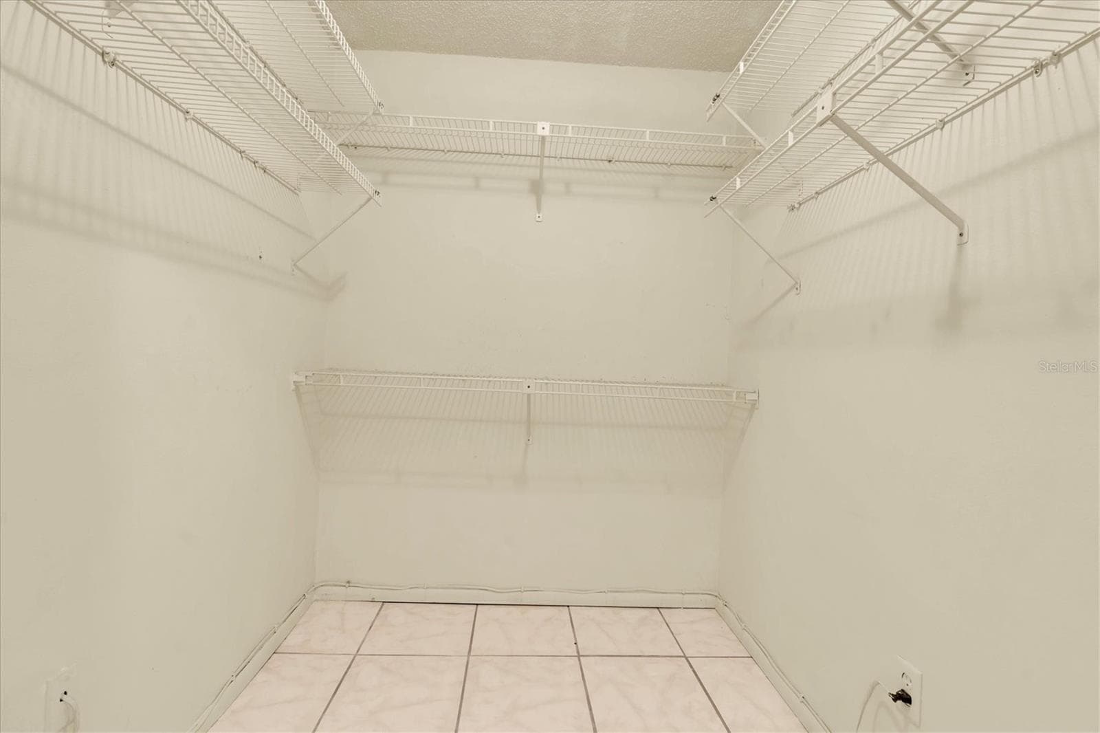 Walk-in closet in the primary bedroom - 8198 TERRACE GARDEN DR #511, ST PETERSBURG