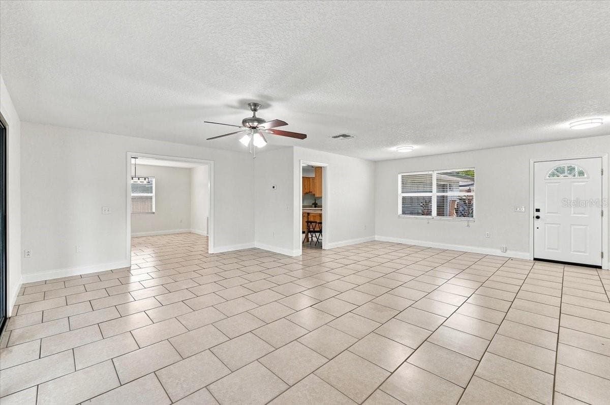 Living room with front door, entry to kitchen and dining room - 121 LOWELL RD, WINTER HAVEN