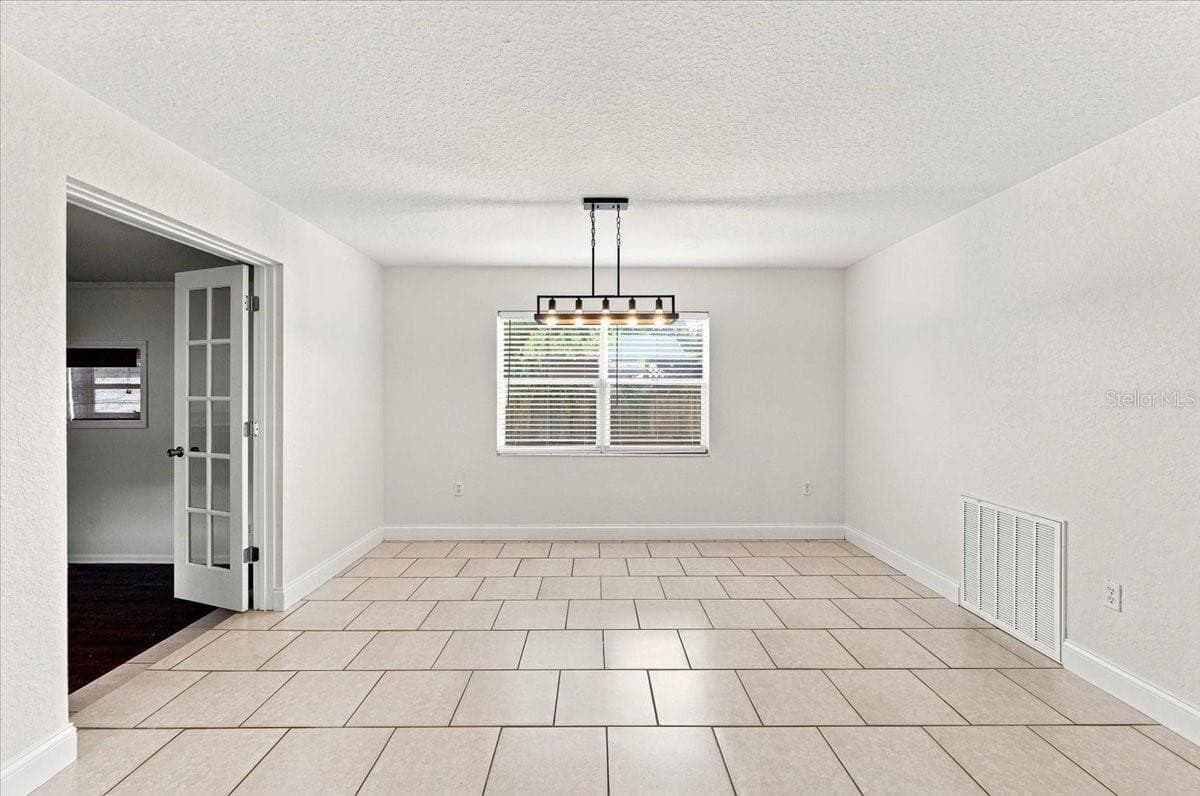 Dining room with double door entry to family room - 121 LOWELL RD, WINTER HAVEN
