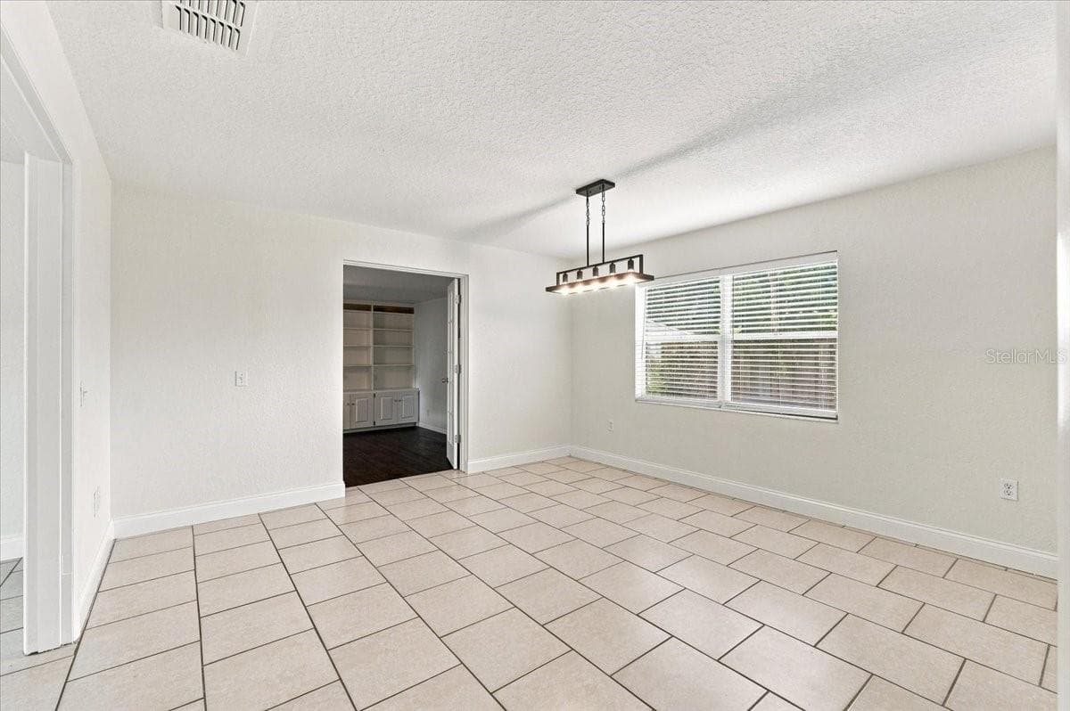 Dining room with double door entry to family room - 121 LOWELL RD, WINTER HAVEN
