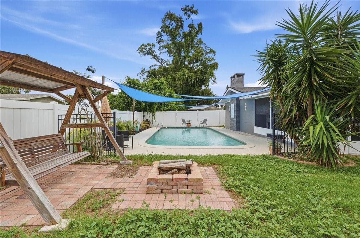 Back yard with firepit and pool - 121 LOWELL RD, WINTER HAVEN