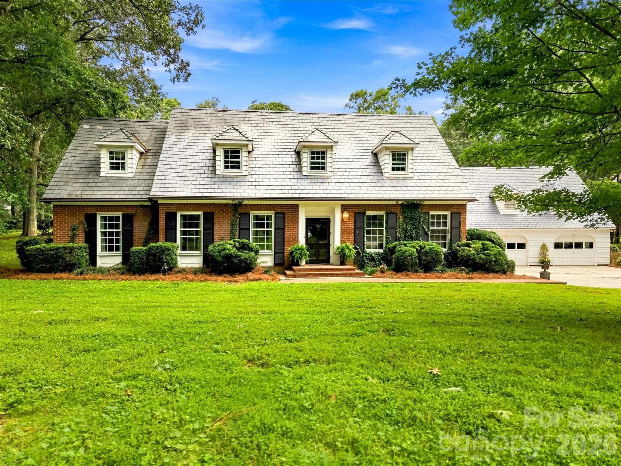 Williamsburg-style home framed by mature trees and established landscaping. - 209 Labans Lane, Lincolnton