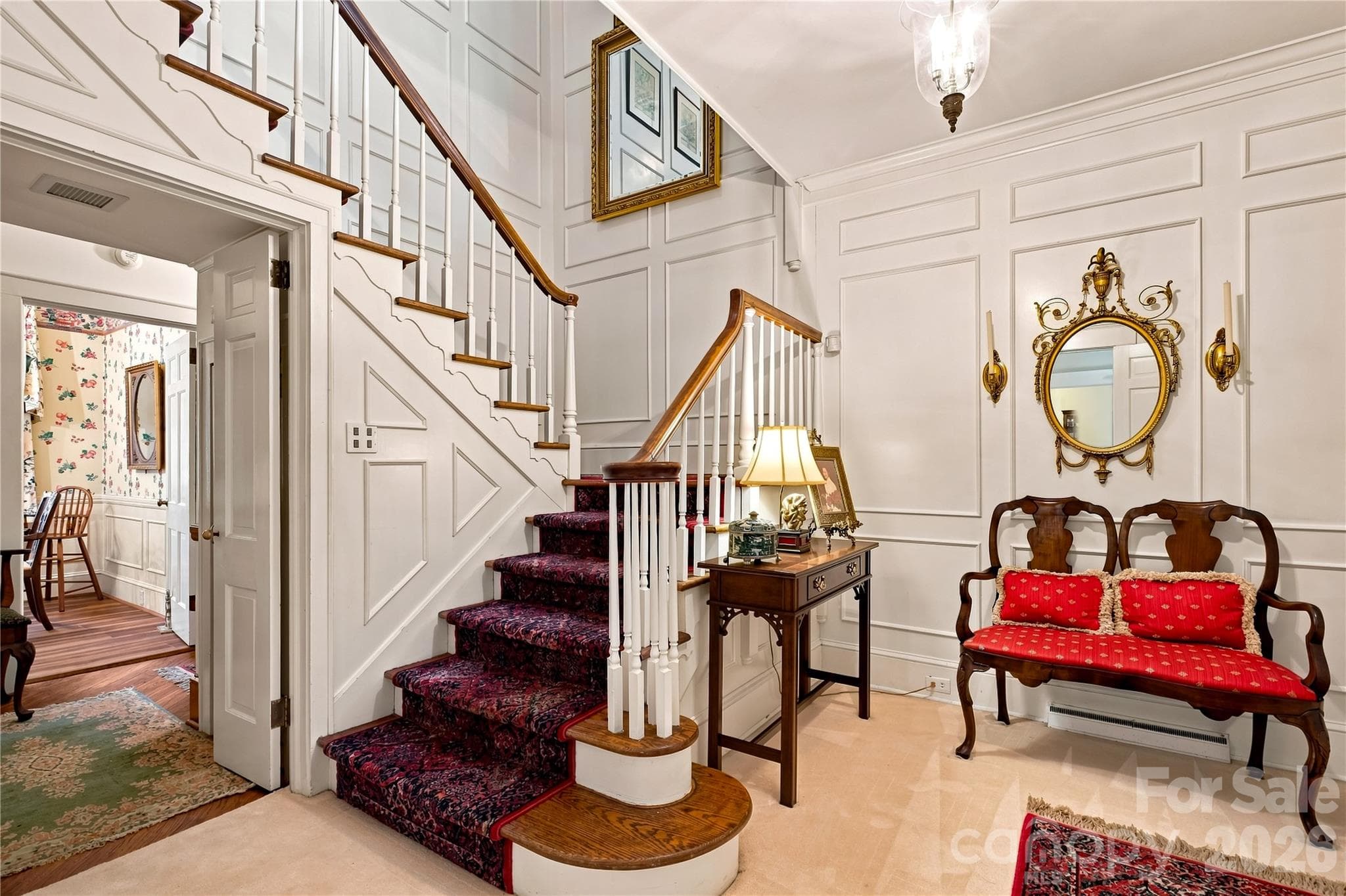 Welcoming foyer with wood staircase, wainscoting and detailed millwork. - 209 Labans Lane, Lincolnton