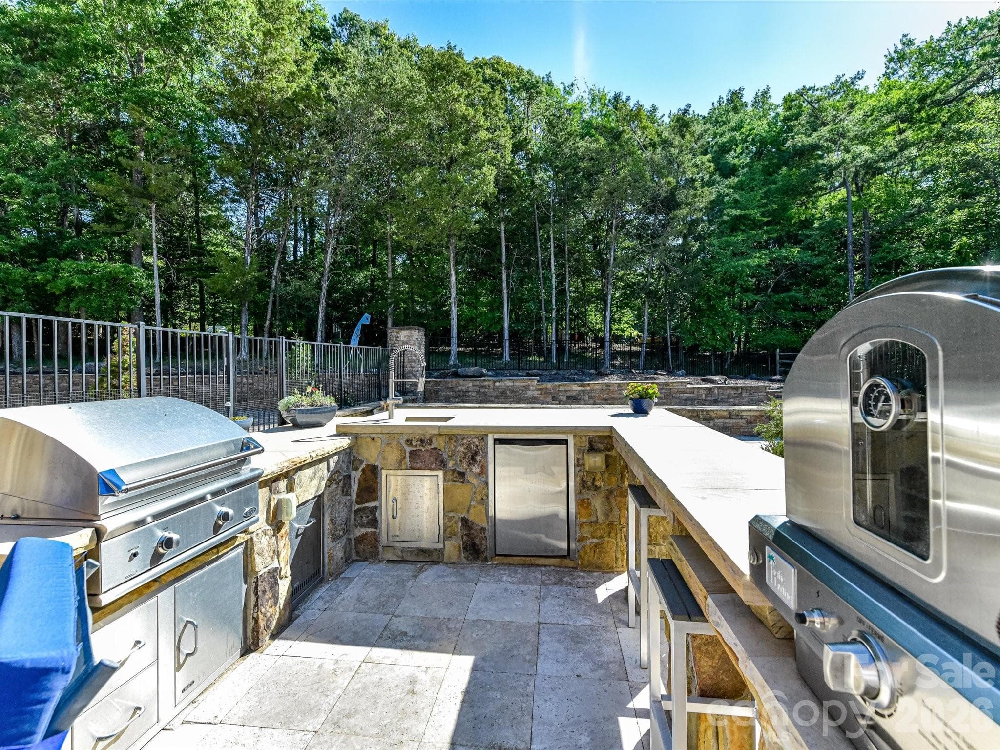 Gas grill, a pizza oven, a sink, a refrigerator, bar seating & more at this outdoor kitchen! - 2723 Providence Pine Lane, Charlotte
