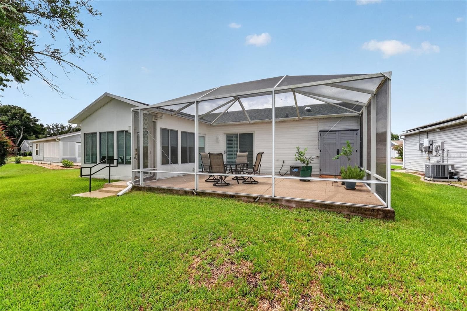 Back of property showing the Glass Enclosed Lanai and Birdcage Lanai. - 1503 ESCANDON PL, THE VILLAGES
