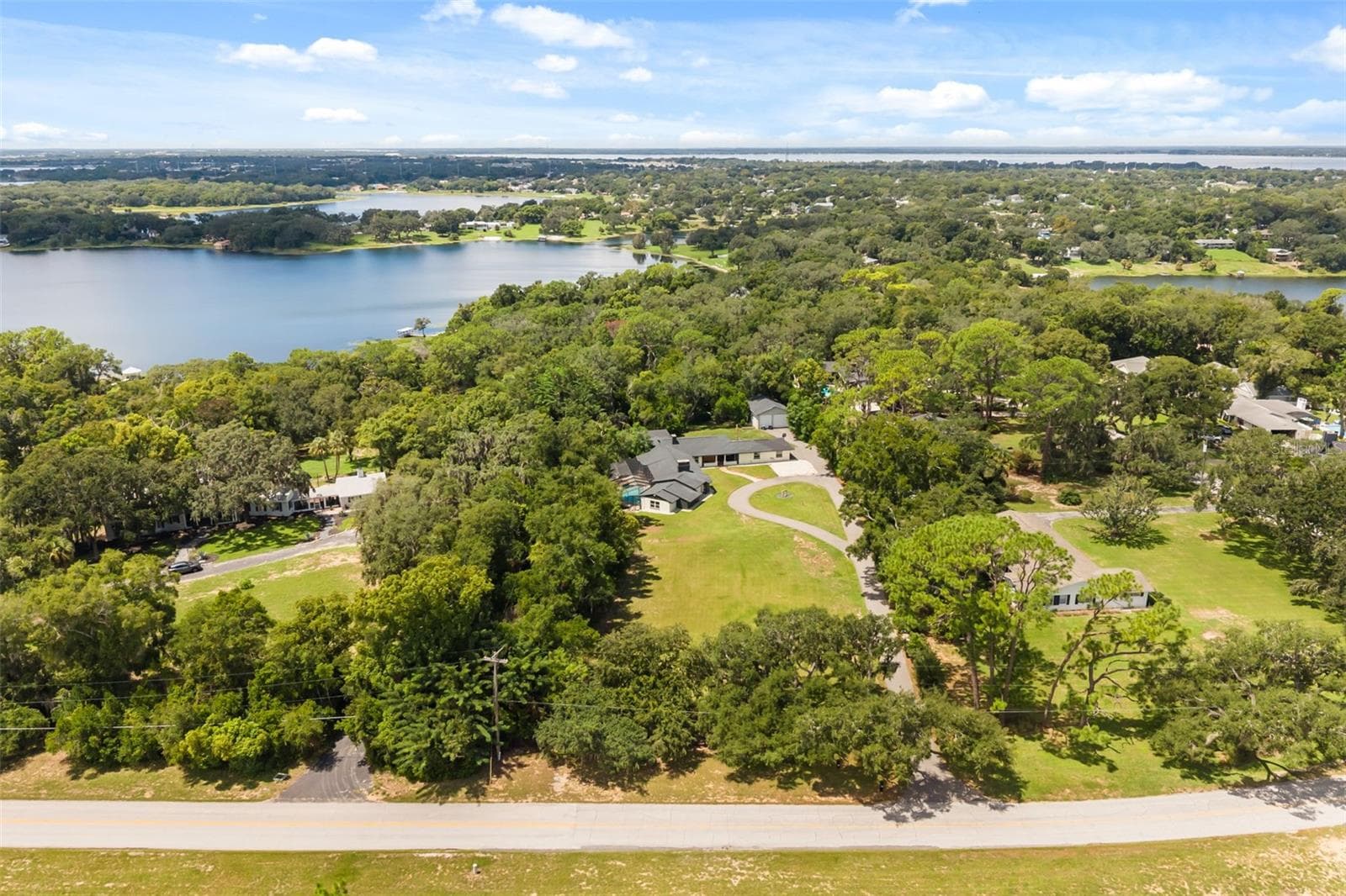 Aerial of the property with views of multiple nearby lakes - 1602 COUNTRY CLUB RD, EUSTIS