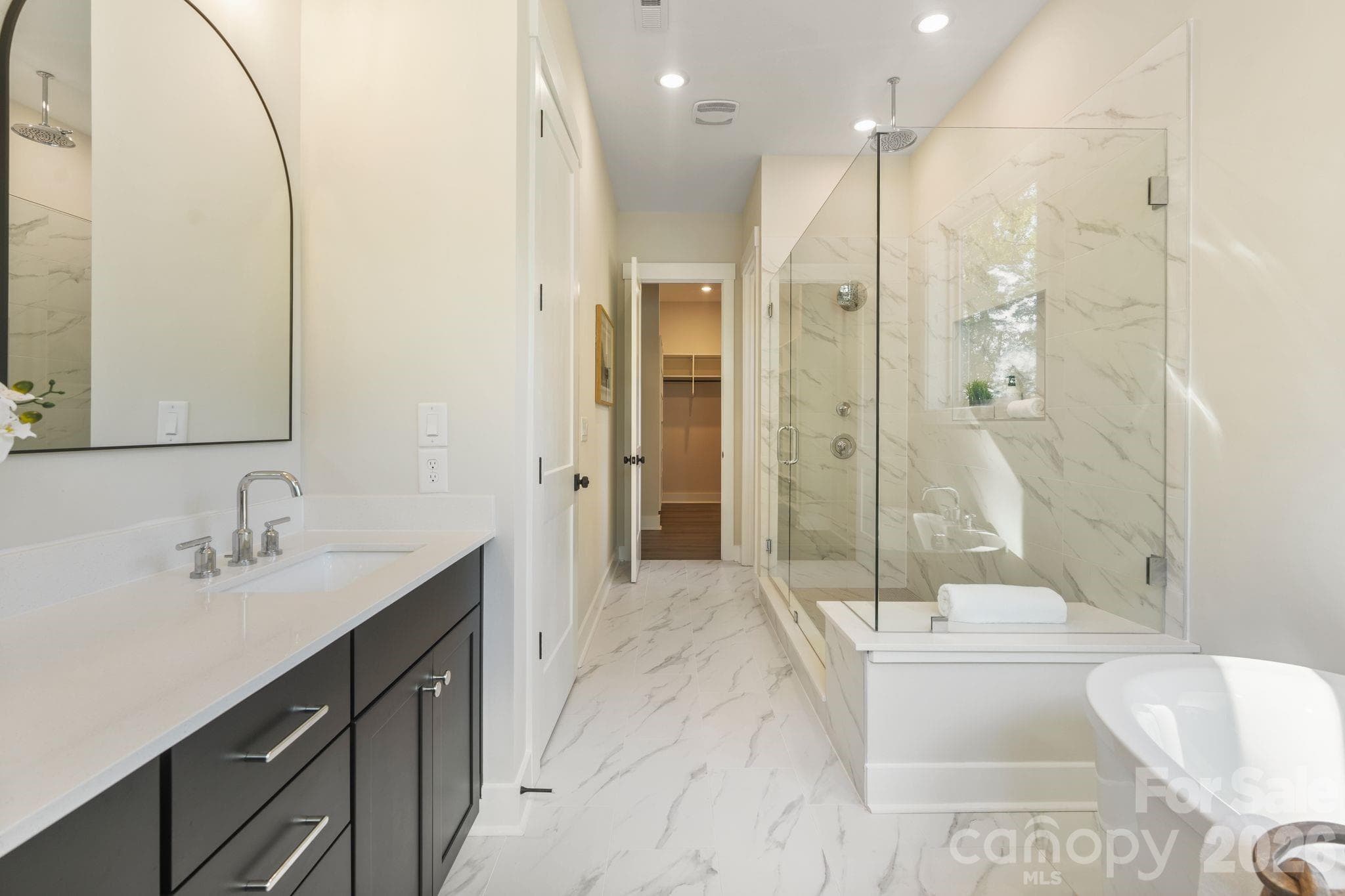 Spa like primary bathroom features rain shower and soaking tub - 4531 Splash Trail, Sherrills Ford