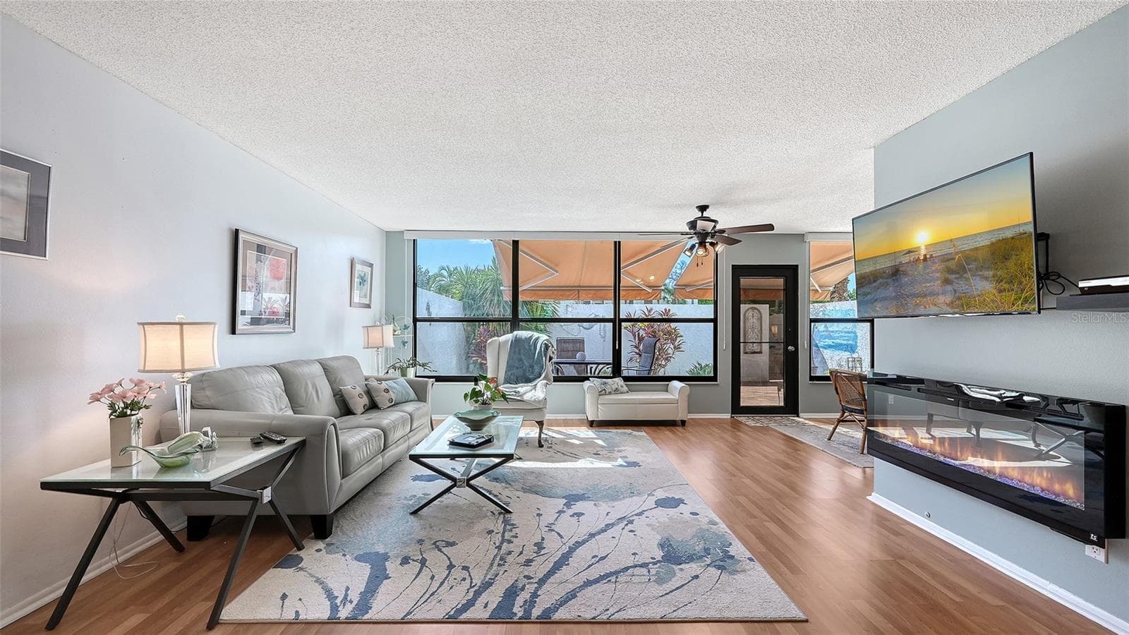 Living room with electric fireplace - 666 WOODLAWN DR #666, BRADENTON