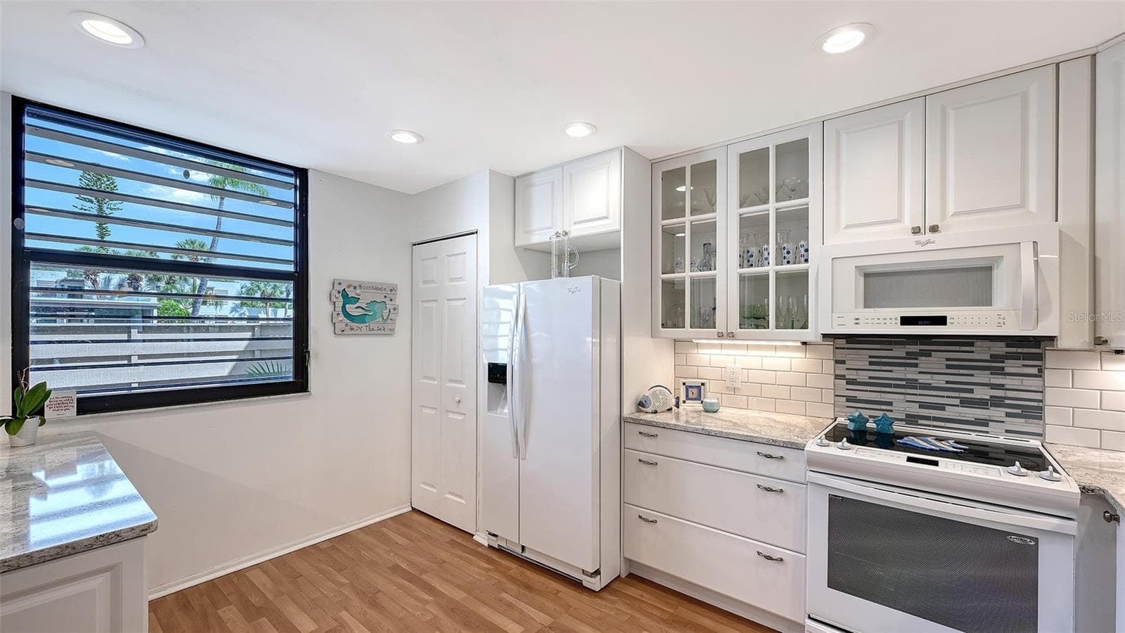 The large window in the back of the kitchen means plenty of natural light for the kitchen - 666 WOODLAWN DR #666, BRADENTON