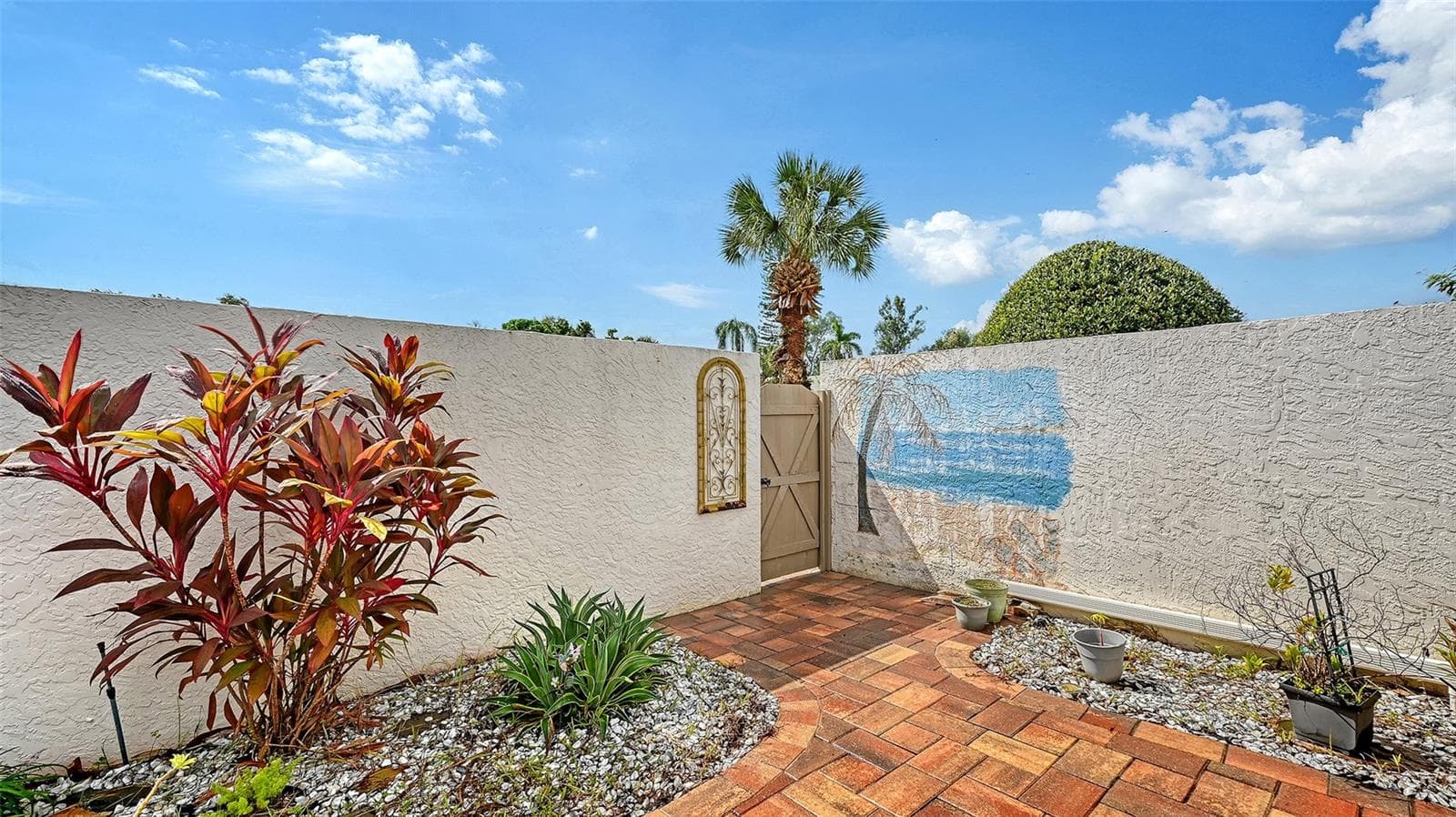 Another shot of the decorated wall the great looking tiled patio. - 666 WOODLAWN DR #666, BRADENTON