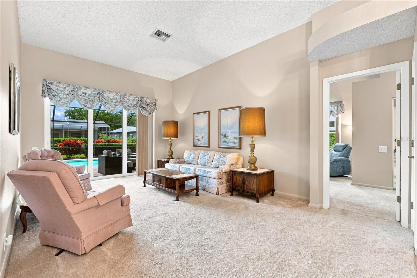 Living Area that goes through the Pool Area & Primary Bedroom - 679 LITCHFIELD LN, DUNEDIN