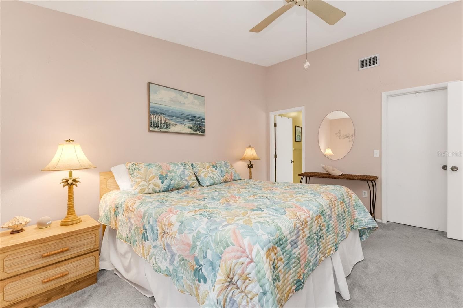 The spacious primary suite offers privacy from the guest bedroom along with direct access to the screened lanai, creating an easy indoor-outdoor connection - 6800 PLACIDA RD #235, ENGLEWOOD