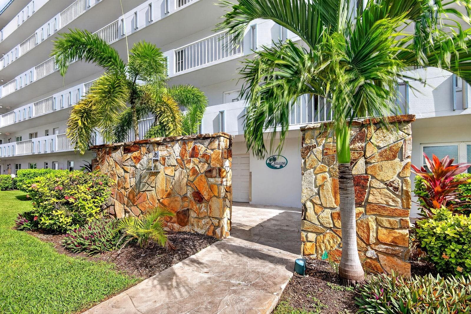 Building showing beautiful landscaping - 4240 IRONWOOD CIR #302A, BRADENTON