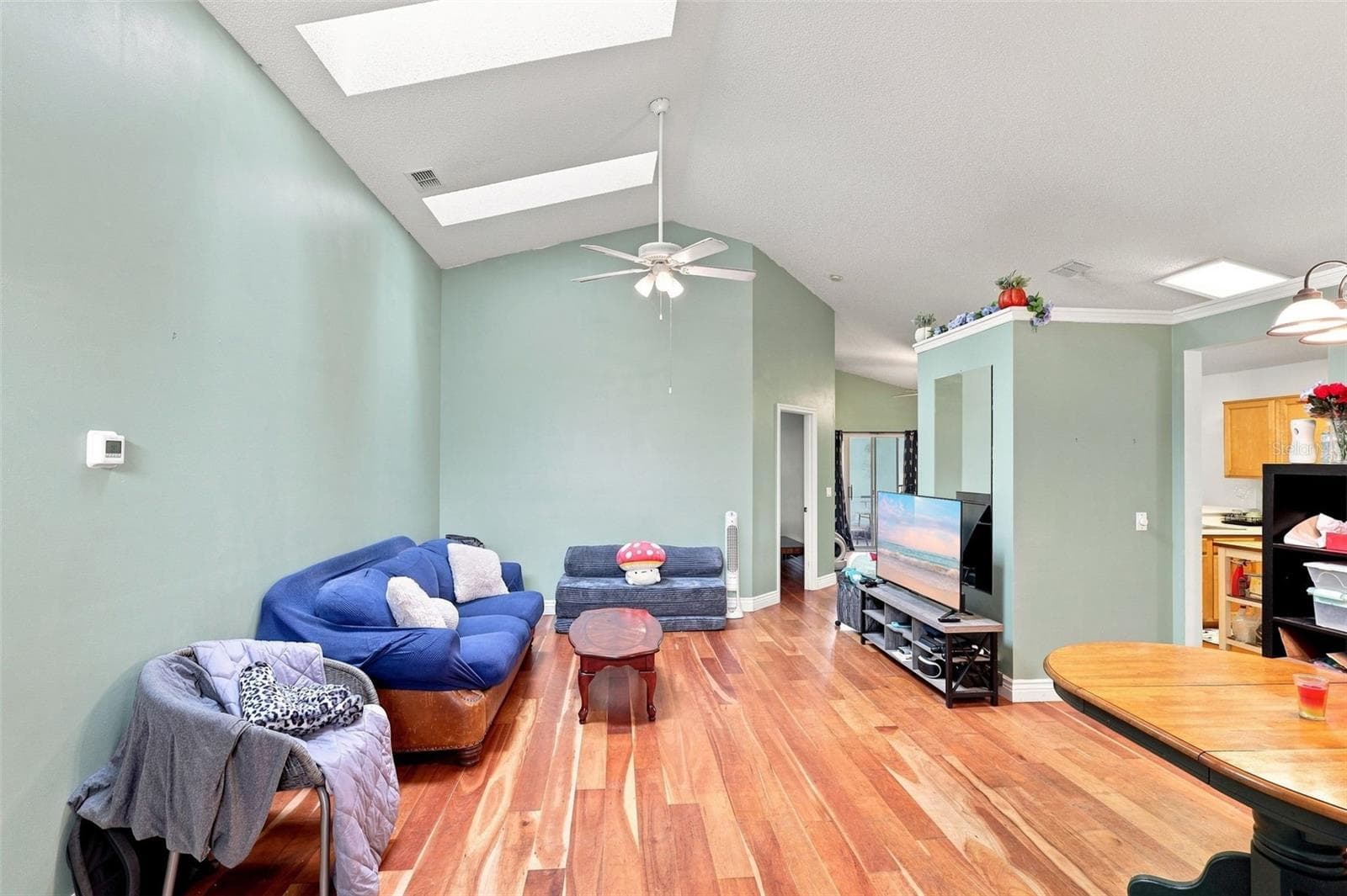 Natural light from the skylights highlights the home's vaulted ceilings and warm wood flooring. - 13637 EMERALDVIEW DR, ORLANDO