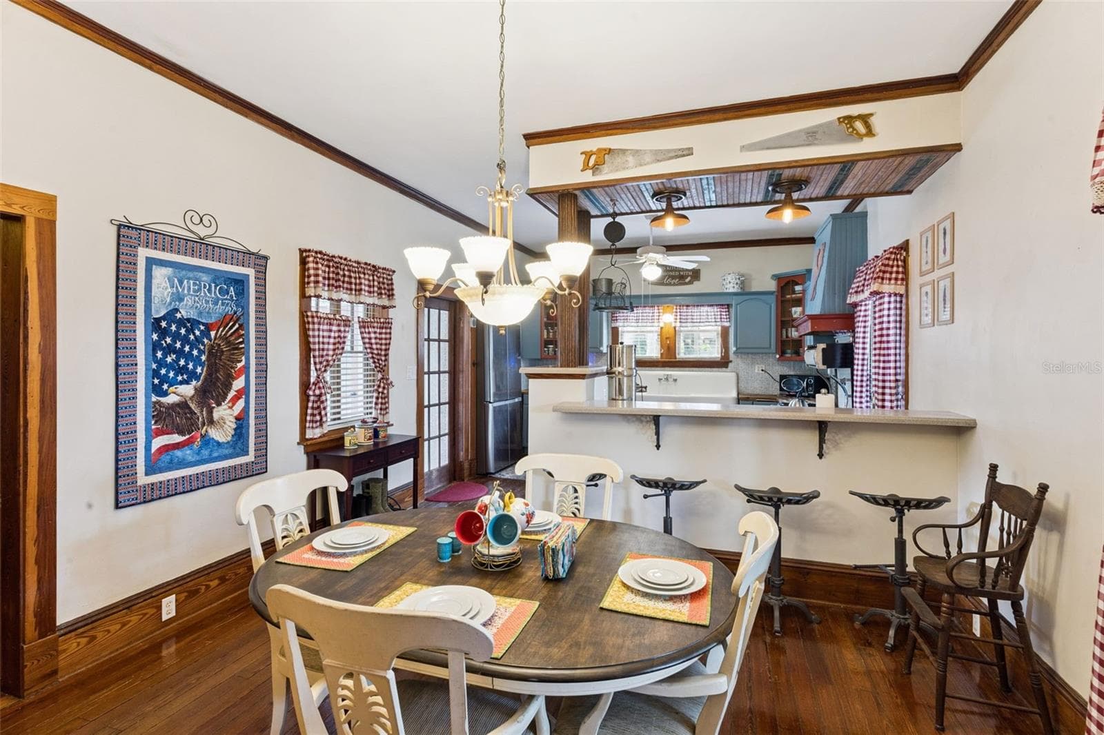 The generous dining room features another fireplace, original wood floors and an easy connection to the kitchen. - 2201 CELERY AVE, SANFORD