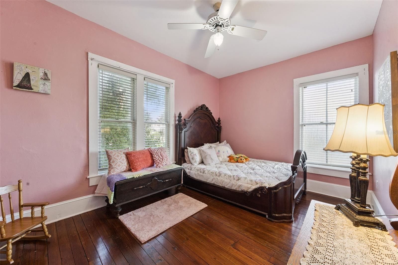 Another spacious upstairs bedroom features beautiful wood floors, tall windows and abundant natural light. - 2201 CELERY AVE, SANFORD