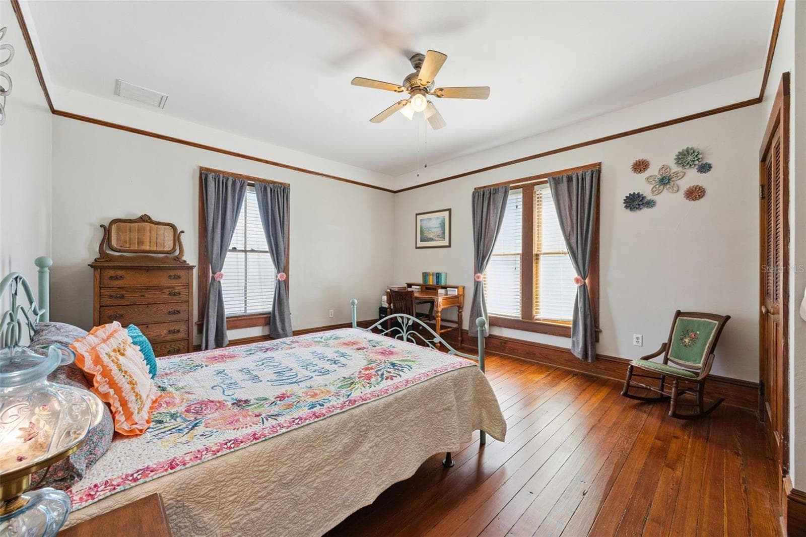 Another spacious upstairs bedroom features beautiful wood floors, tall windows and abundant natural light. - 2201 CELERY AVE, SANFORD