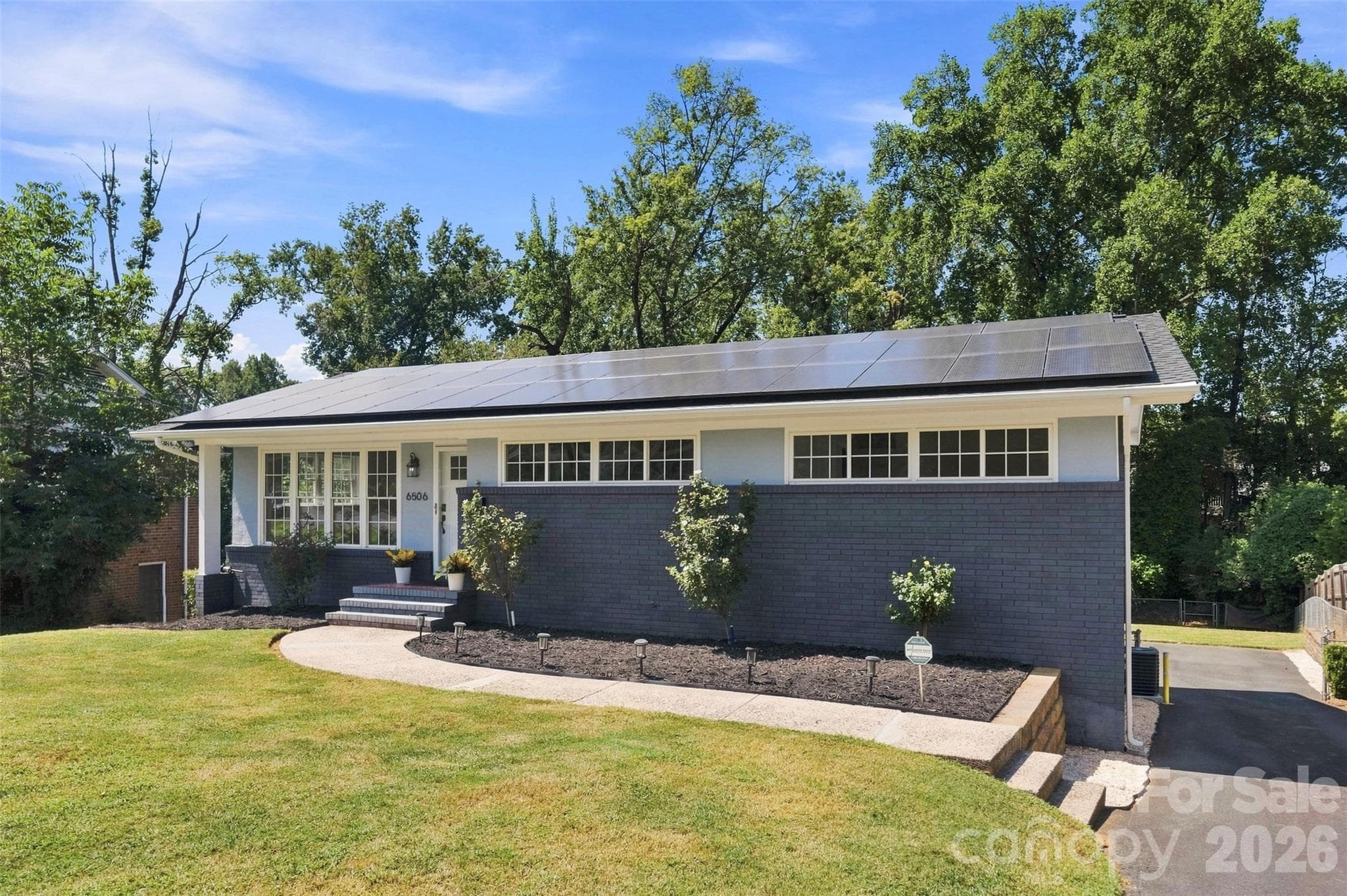 Timeless Mid-Century modern design meets beautifully landscaped curb appeal. This is a great looking home. - 6506 Candlewood Drive, Charlotte