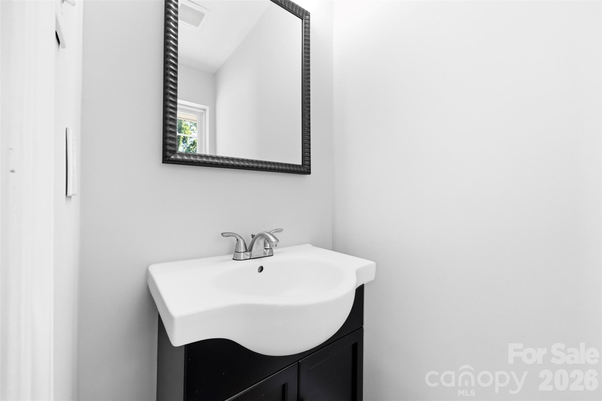 An original mid-century modern detail, this private powder room is thoughtfully integrated into the primary BR. - 6506 Candlewood Drive, Charlotte