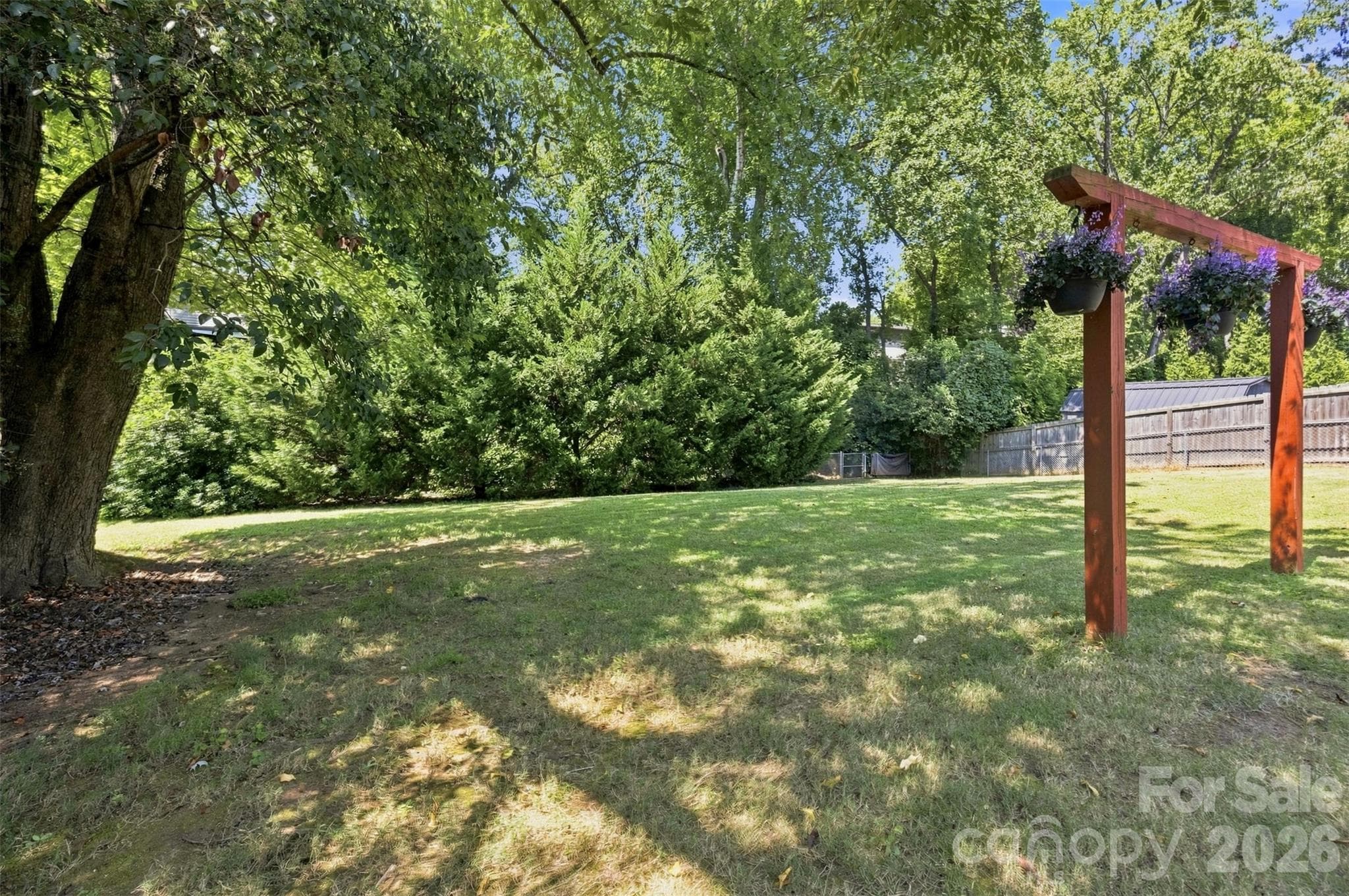 This is a photo of the private tree-lined backyard retreat. Current owners had fun parties and gatherings over the years here. Turn up the aura with outdoor tree lighting ! - 6506 Candlewood Drive, Charlotte