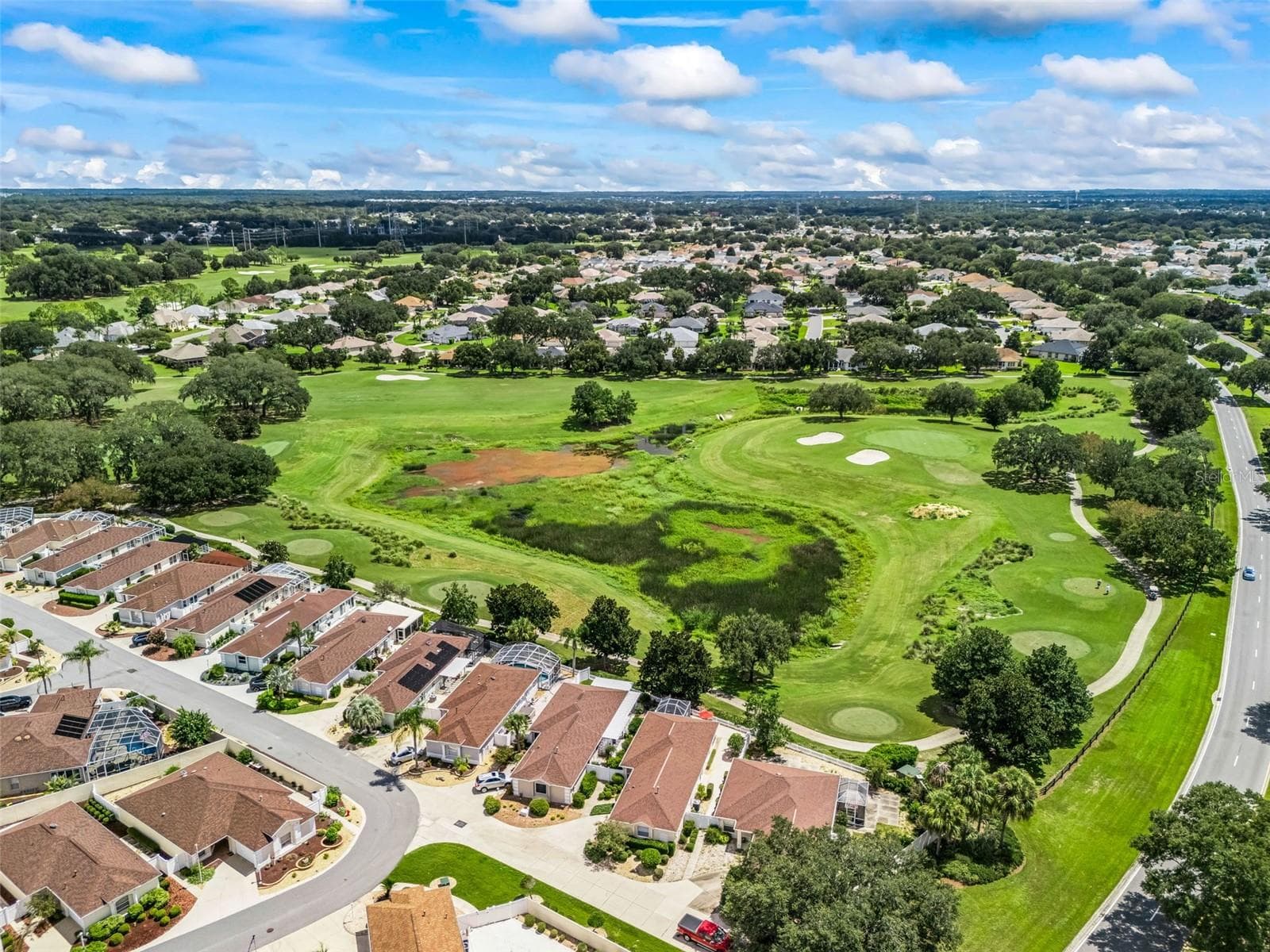 This elevated perspective showcasing this beautiful home and its prime golf course setting, with the scenic fairway extending directly beyond the backyard. Enjoy the beauty and serenity of golf course living right outside your back door. - 17535 SE 84TH FOXGROVE AVE, THE VILLAGES