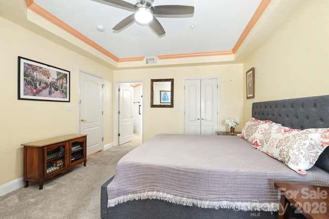 Primary en-suite features trey ceiling and ceiing fan, with walk-in closet. - 401 N Church Street, Charlotte
